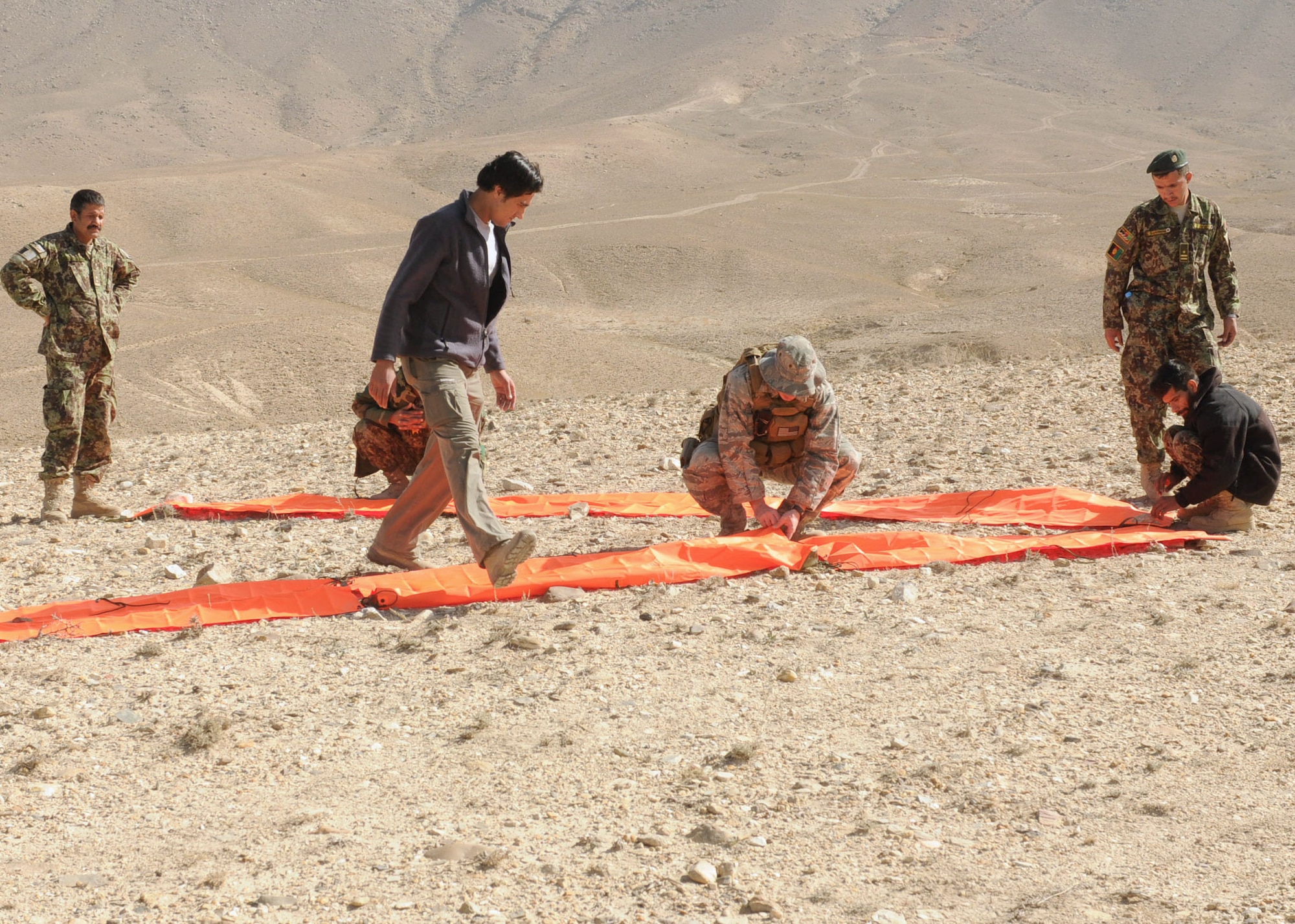 Afghan life support airmen practice using signaling devices. They will begin teaching this skill to Afghan air force pilots so they know how to signal for rescue. (U.S. Navy photo/Petty Officer 3rd Class Jared Walker) 