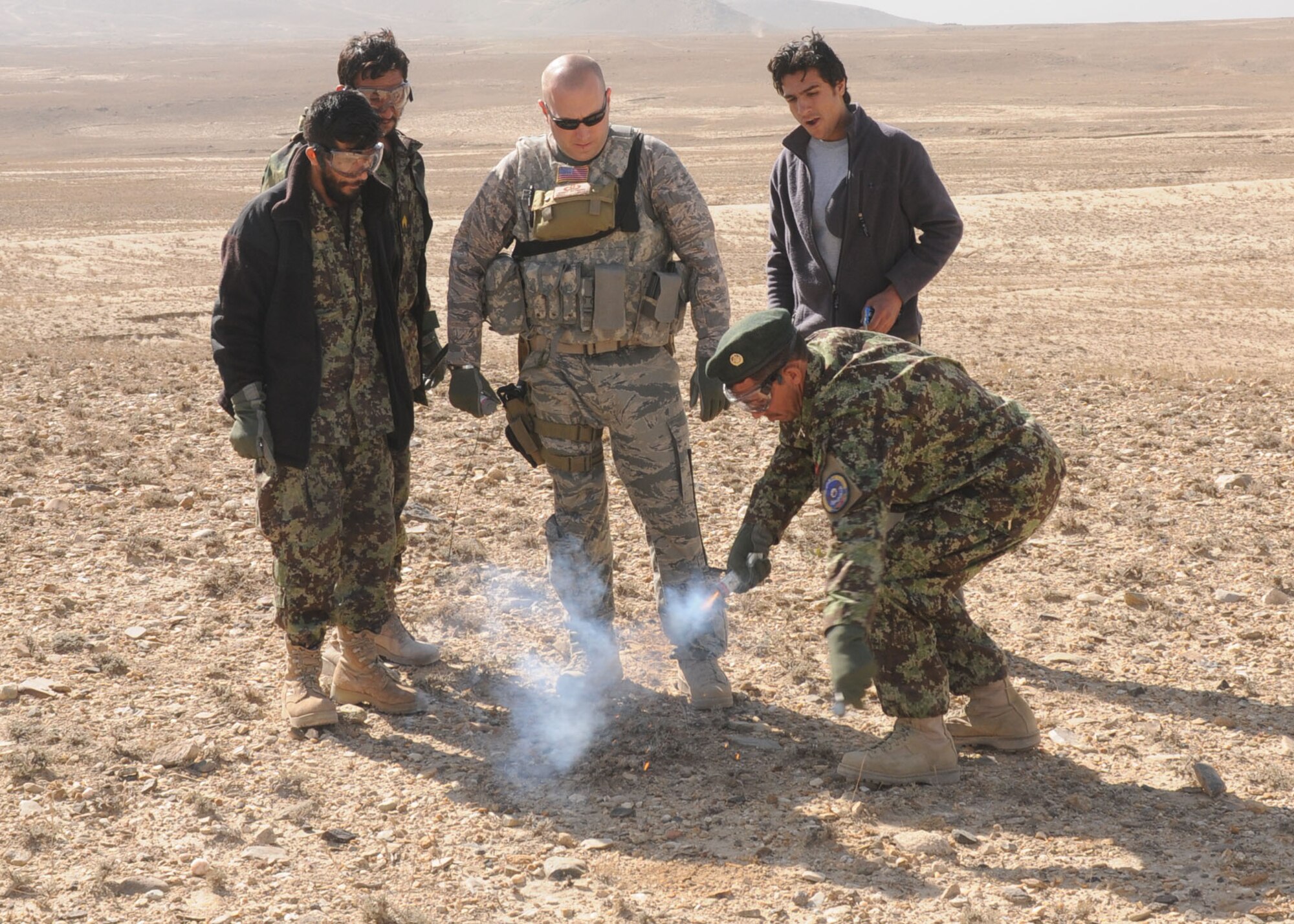Afghan life support airmen practice using signaling devices. They will begin teaching this skill to Afghan air force pilots so they know how to signal for rescue. (U.S. Navy photo/Petty Officer 3rd Class Jared Walker) 