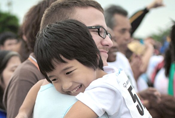 Airman 1st Class Matthew Renfro gives Yuto Uehara a hug for luck before Yuto's next event Nov. 6, 2010, during the Kadena Special Olympics at Kadena Air Base, Japan. Airman Renfro was a volunteer hugger for the event. He is assigned to the 18th Munitions Squadron. (U.S. Air Force photo/Airman 1st Class Tara A. Williamson) 