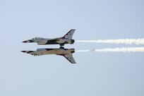 The Thunderbirds fly a mirror image pattern during AirFest 2010 at Lackland Nov. 6. (U.S. Air Force photo/Robbin Cresswell)