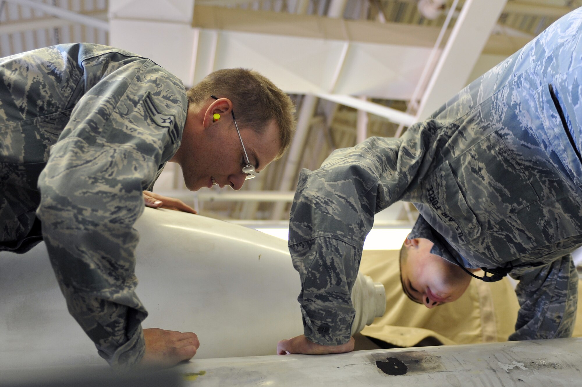 WHITEMAN AIR FORCE BASE, Mo. - Airman 1st Class Coty Baird (left) and Airman 1st Class Carlos Solorza III, 19th Munitions Squadron, perform inspections on training weapons, Nov. 8. Airman Baird and Airman Solorza, special assets team members, safely performed tasks using training weapons, trailers, tow vehicle and associated equipment. (U.S. Air Force photo/Tech. Sgt. Charles Larkin Sr)