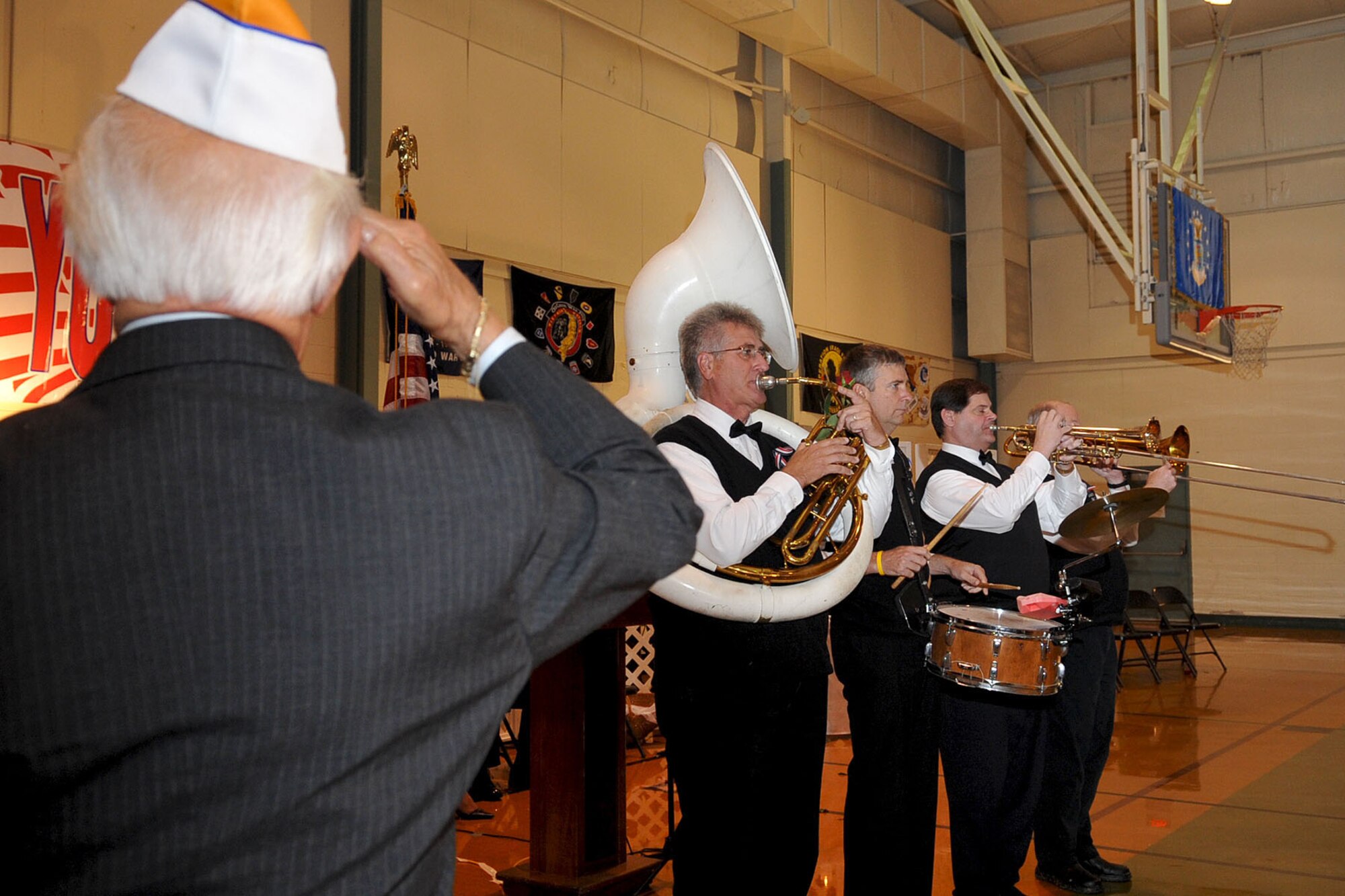 CHESAPEAKE, Va. -- Retired Col. Pete Arturo Carter salutes the U.S. flag while the Royal Atlantic Ceremonial Band plays the Air Force song during the Veteran's Day ceremony Nov. 4. The Niners Citizen's Club hosted the event at the South Norfolk Community Recreation Center to honor all active-duty and retired military.(U.S. Air Force photo/Staff Sgt. Ashley Hawkins)(RELEASED)