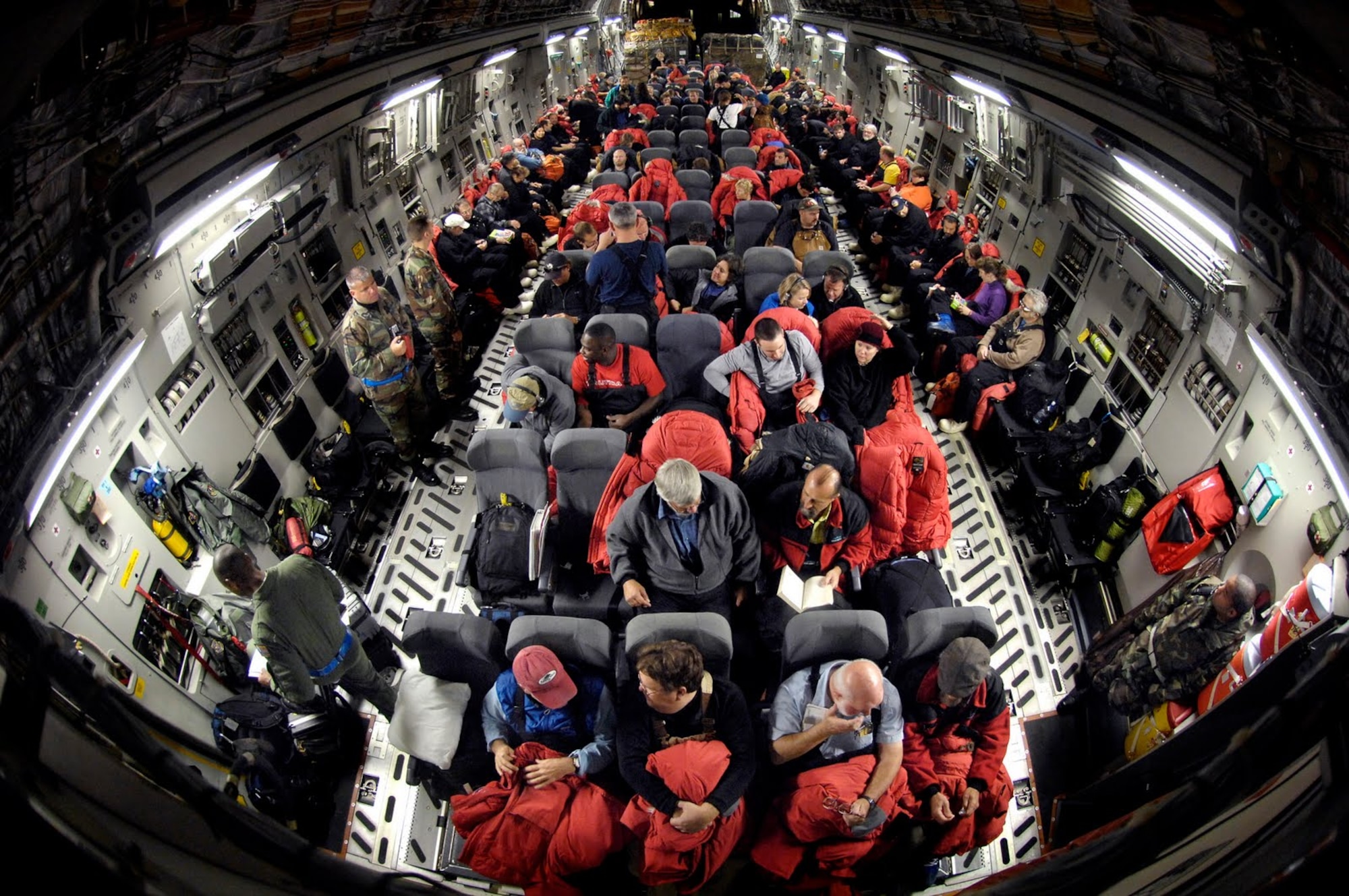 Personnel from the National Science Foundation travel via a U.S. Air Force C-17 Globemaster III en route to McMurdo Station, Antarctica, on October 28, 2010. The U.S. Air Force, Navy, Army, and Coast Guard are lending operational and logistical support to the NSF's research and exploration efforts in Antarctica. This support is provided by the Joint Task Force Support Forces Antarctica, led by 13th Air Force at Joint Base Pearl Harbor-Hickam, Hawaii. JTF SFA coordinates strategic intertheater airlift, tactical deep field support, aeromedical evacuation support, search and rescue response, sealift, seaport access, bulk fuel supply, port cargo handling, and transportation requirements. Operation Deep Freeze is scheduled through Feb. 24, 2011. (courtesy photo)