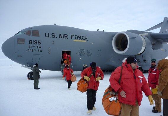 Personnel from the National Science Foundation depart a U.S. Air Force C-17 Globemaster III at McMurdo Station, Antarctica, on October 28, 2010. The U.S. Air Force, Navy, Army, and Coast Guard are lending operational and logistical support to the NSF's research and exploration efforts in Antarctica. This support is provided by the Joint Task Force Support Forces Antarctica, led by 13th Air Force at Joint Base Pearl Harbor-Hickam, Hawaii. JTF SFA coordinates strategic intertheater airlift, tactical deep field support, aeromedical evacuation support, search and rescue response, sealift, seaport access, bulk fuel supply, port cargo handling, and transportation requirements. Operation Deep Freeze is scheduled through Feb. 24, 2011.  (courtesy photo)
