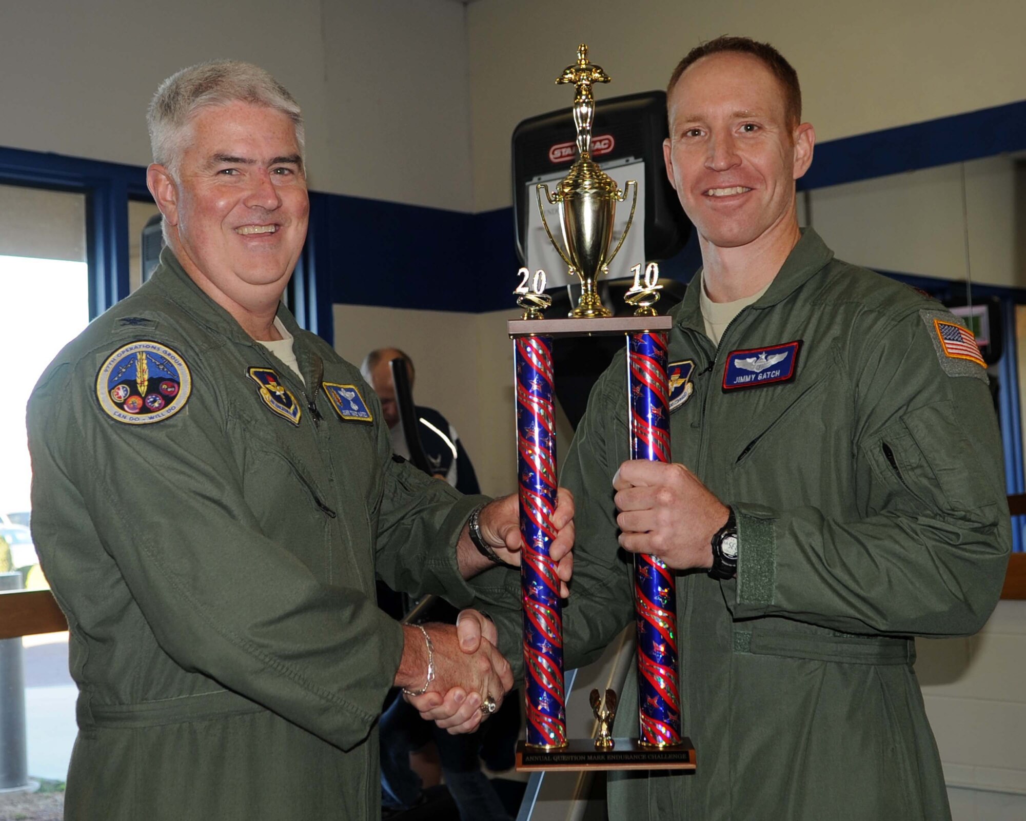 ALTUS AIR FORCE BASE, Okla.--Col Odie Oates, 97th Operations Group commander, awards the Question Mark Endurance Challenge trophy to Maj Jimmy Gatch, 54th Air Refueling Squadron Director of Operations Nov 4. The 54th ARS placed first by burning 11,096 calories. A total of five teams competed and burned a total of 43,986 calories within 12 hours as well as raised $150 towards the Combined Federal Campaign. (U.S. Air Force photo/Senior Airman Leandra D. Stepp/Released 97th Air Mobility Wing Public Affairs) 