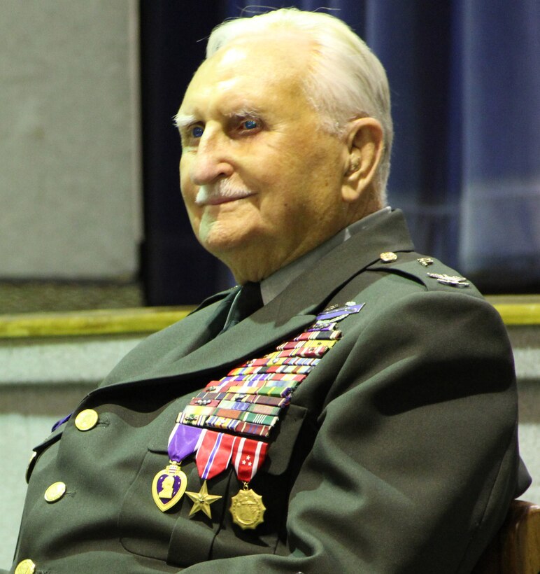 PATRICK AIR FORCE BASE, Fla. ? Colonel Glenn Frazier (Ret.), an American Prisoner of War and Bataan Death March survivor from April 9, 1942 to Sept. 4, 1945, speaks to the Airmen of the 920th Rescue Wing here, November 6, 2010. On his chest he wears the Medal of Freedom, Bronze Star, Purple Heart, and more. (U.S. Air Force photo/Staff Sgt. Leslie Kraushaar)