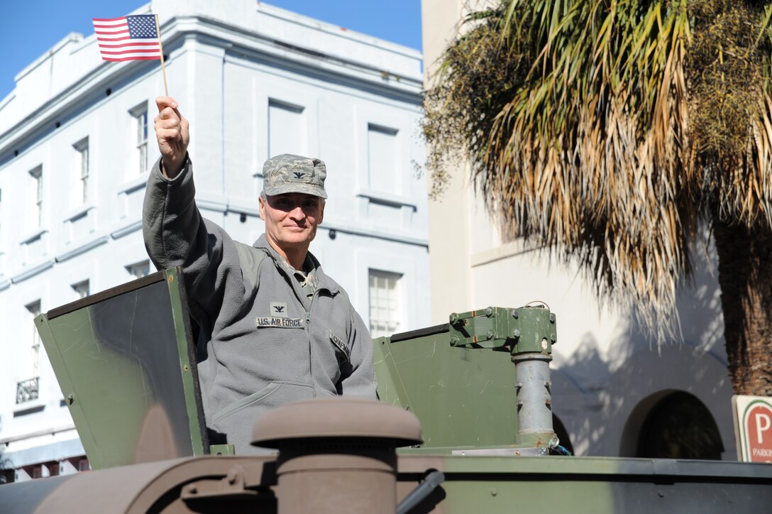 Col. Steven Chapman, commander of the 315th Airlift Wing, waves to spectators from the turret of a HUMVEE in the Charleston, SC Veterans Day Parade November 7, 2010. About 80 Reservists volunteered their time to participate in the parade honoring those who serve and have served in our nation's military. (U.S. Air Force Photo/James Bowman)