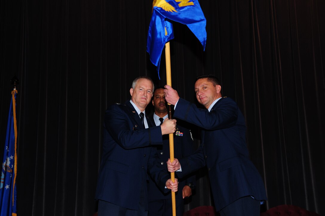 Mission Support Group Commander Timothy McCoy passes the Force Support Squadron’s guidon to it’s new commander,  Maj Paul Delano at the Roberts Joint Training Center November 7 on the Niagara Falls Air Reserve Station, Niagara Falls, N.Y. (Photo by Senior Airman Jessica Snow) 