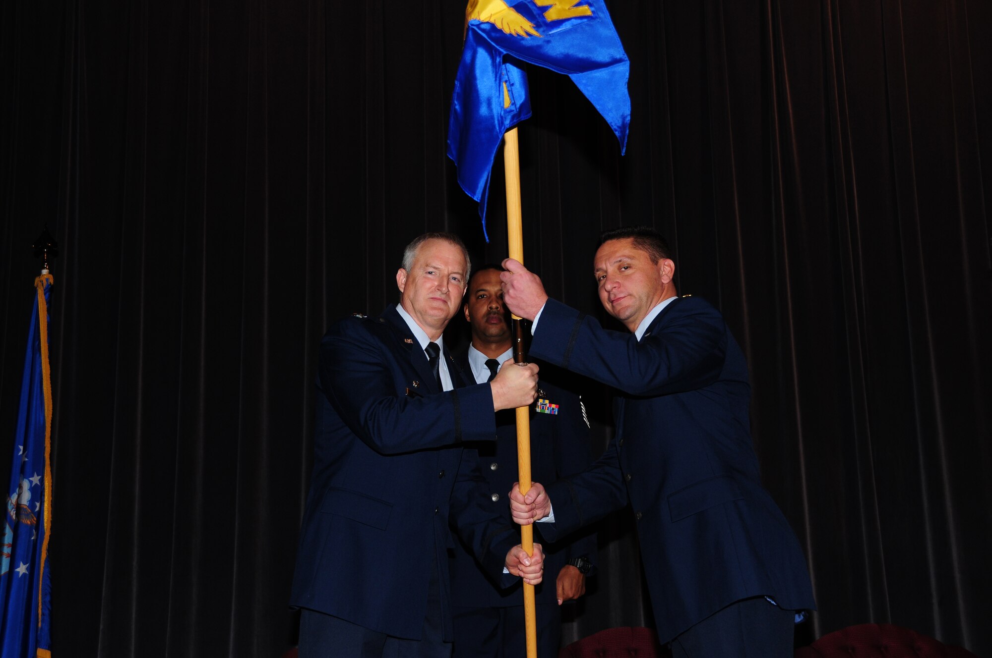 Mission Support Group Commander Timothy McCoy passes the Force Support Squadron’s guidon to it’s new commander,  Maj Paul Delano at the Roberts Joint Training Center November 7 on the Niagara Falls Air Reserve Station, Niagara Falls, N.Y. (Photo by Senior Airman Jessica Snow) 