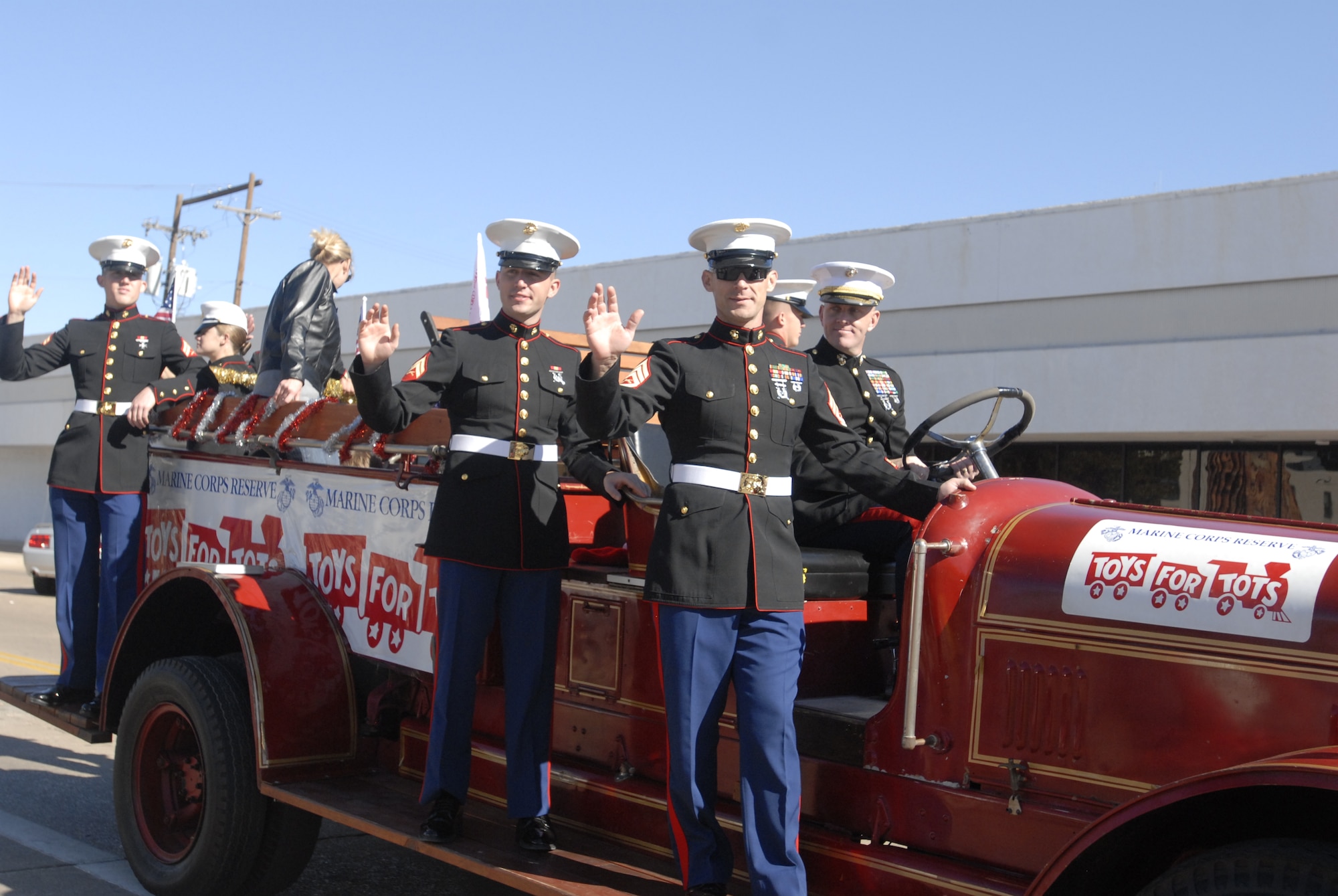 GOODFELLOW AIR FORCE BASE, Texas – Marines from the Marine Corps Reserve wave to spectators during the San Angelo Veterans Day Parade held Nov. 6., to honor veterans for their service and sacrifice to the country. They also promoted their Toys for Tots program which collects new, unwrapped toys each year and distributes them as Christmas gifts to needy children in the community. (U.S. Air Force photo /Airman 1st Class Anne Gathua)