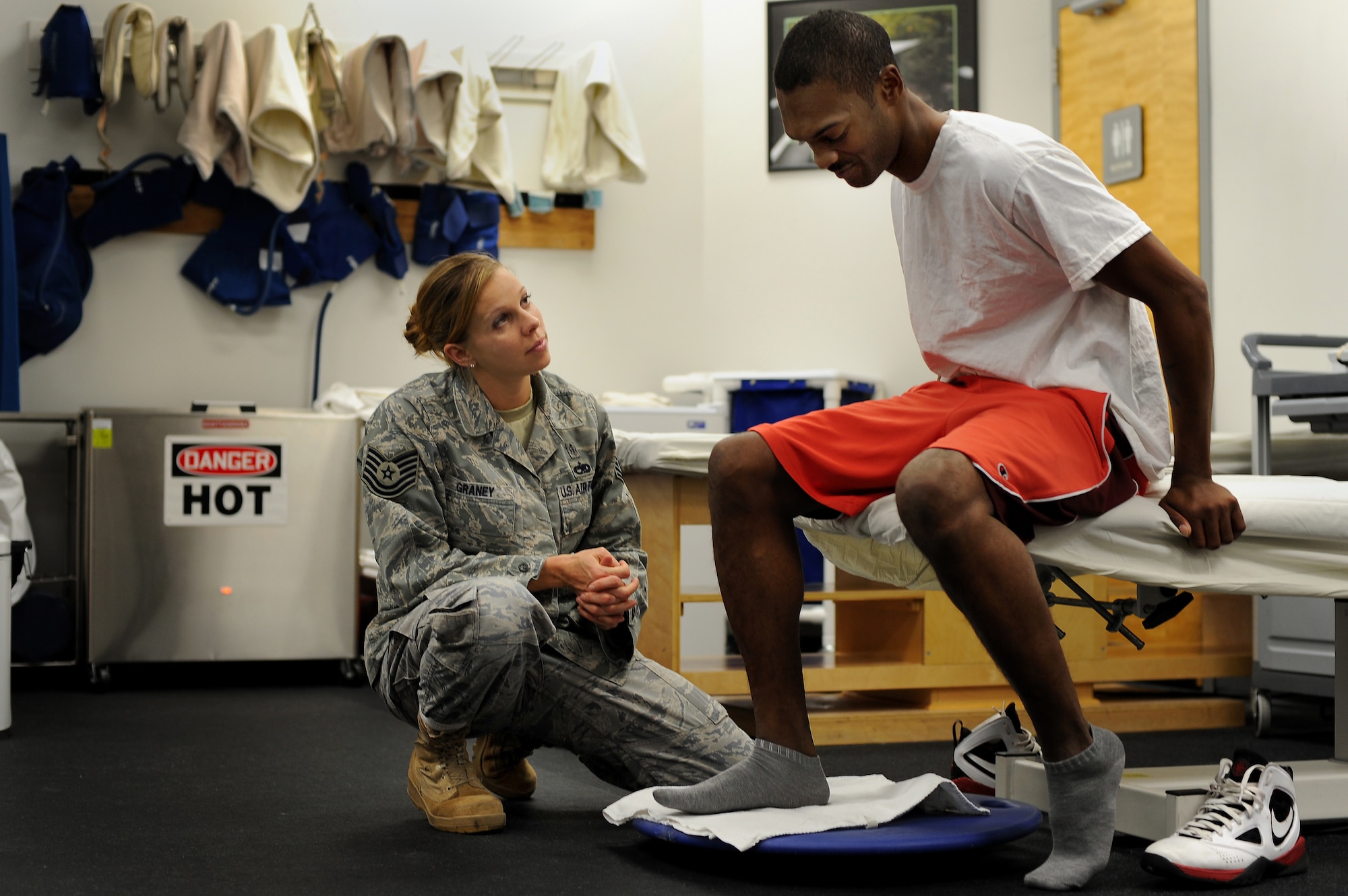 Tech. Sgt. Eva Graney, 509th Medical Group physical therapy NCO in charge, works physical progression with a patient, Nov. 5. Sergeant Graney works with the physical therapy staff to ensure patients make strong recoveries, regardless of how mild or severe the injury. (U.S. Air Force photo by Senior Airman Kenny Holston)(Released)  


