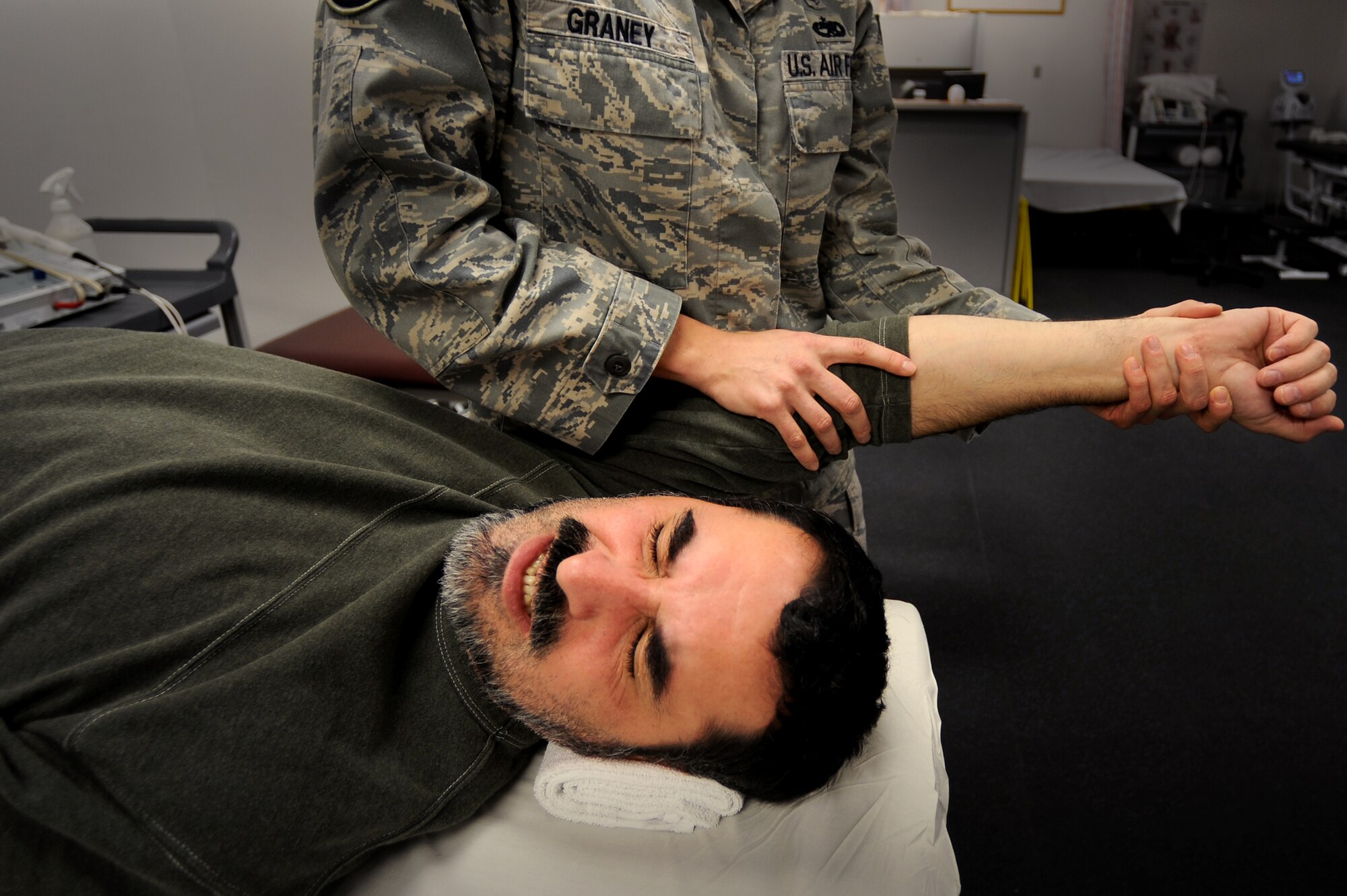 Tech. Sgt. (ret.) Ben Anderson undergoes intense physical therapy with Tech. Sgt. Eva Graney, 509th Medical Group physical therapy NCO in charge, after having surgery for a torn rotator cuff, Nov. 5. Sergeant Anderson has been in therapy for two and a half months and will continue therapy for another three months before making a full recovery. (U.S. Air Force photo by Senior Airman Kenny Holston)(Released)  

