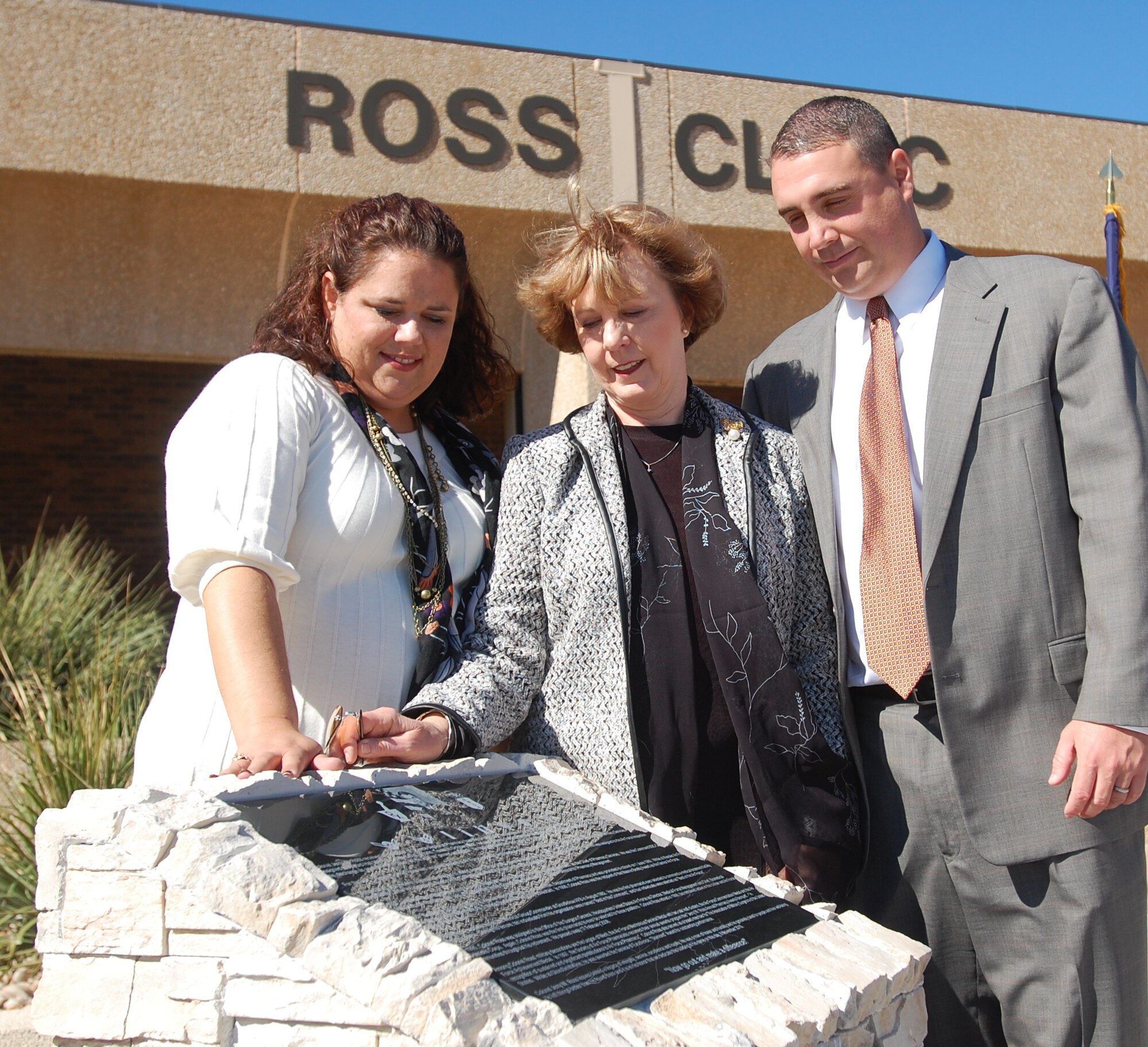 GOODFELLOW AIR FORCE BASE, Texas -- From left: Shannon Summar-Ross, Sally Ross and Jason Ross take a few moments to look over the plaque which dedicates and renames the 17th Medical Group Military Treatment Facility to the Ross Clinic.  The building was officially renamed after their father and husband, Col. Jerry Ross, who was the 17th MDG Commander from 1992-1995, during a building dedication ceremony Nov. 8. (U.S. Air Force photo/Staff Sgt. Heather Rodgers)