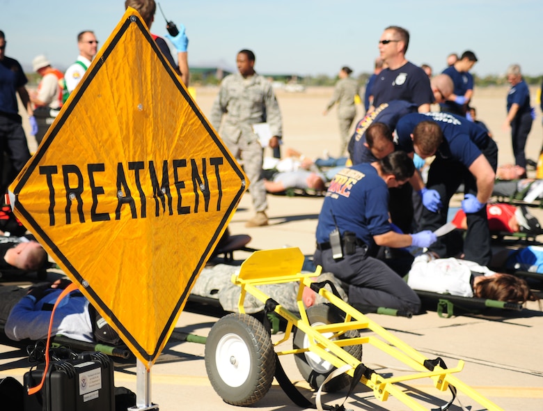 DAVIS-MONTHAN AIR FORCE BASE, Ariz. - Crisis responders from D-M and various agencies of Tucson, provide treatment to mock patients during a National Disaster Medical Systems Exercise on the Snowbird ramp here Nov. 4. The NDMSE exercise is designed to test the ability of military and civilian medical groups to work together to provide fast and efficient care to patients in the event of a crisis. (U.S. Air Force photo/Airman 1st Class Jerilyn Quintanilla)