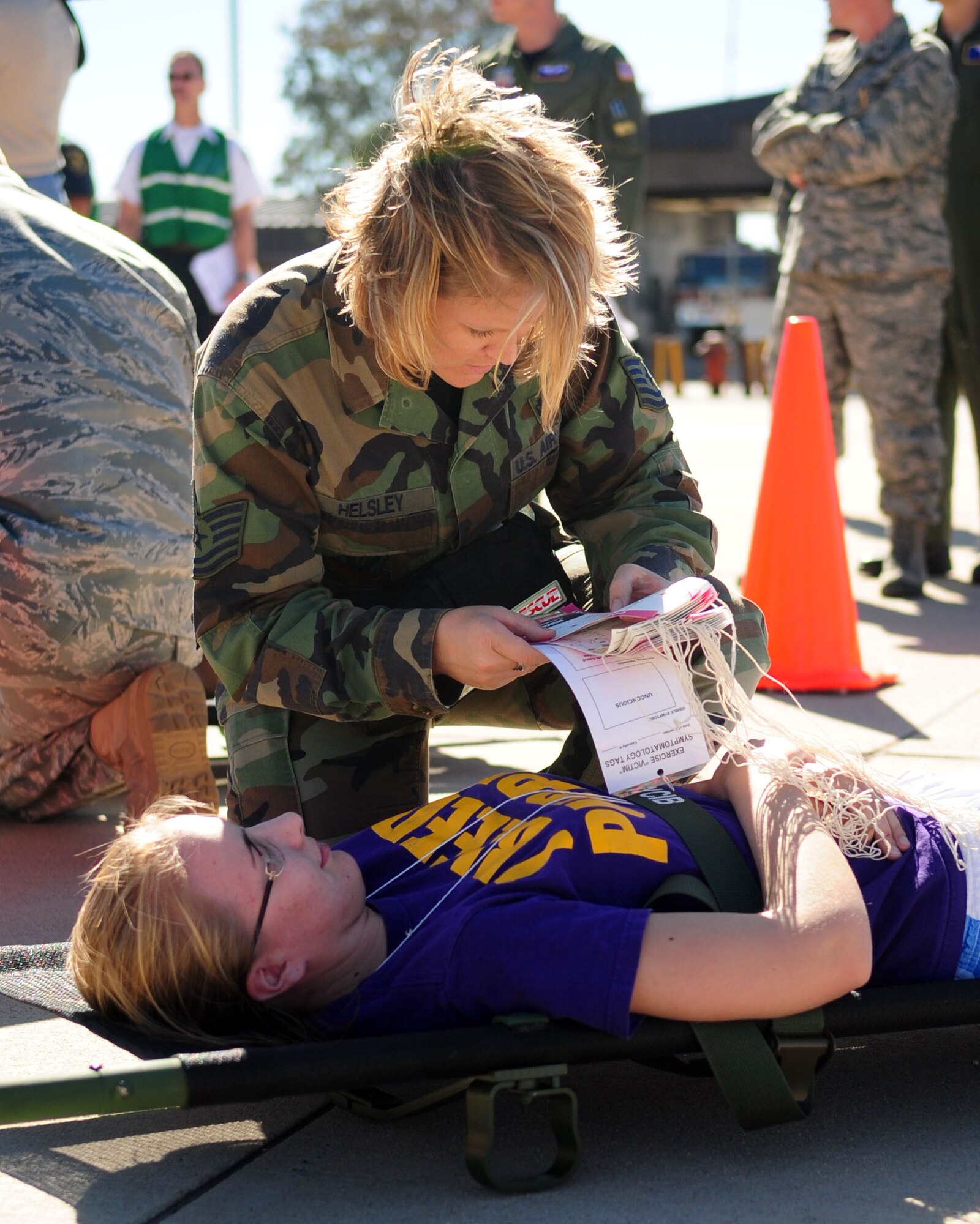 DAVIS-MONTHAN AIR FORCE BASE, Ariz. - Tech. Sgt. Nichole Helsley, from the 355th Aerospace Medicine Squadron, performs an initial medical assessment on a patient as part of a National Disaster Medical Systems Exercise on the Snowbird ramp here Nov. 4. Airmen from the 355th MDG and civilian medical personnel from various agencies in Tucson participated in the NDMSE, which is designed to test the ability of military and civilian medical groups to work together to receive casualties, provide triage, and transport patients to area hospitals in the event of a crisis. (U.S. Air Force photo/Airman 1st Class Jerilyn Quintanilla)