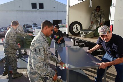 Randolph AFB, TX, Randolph AFB, TX, 4 November 2010:  Members of the 902nd Mission Support Group transfer their bags to a vehicle to carry their field bags from the staging area during an exercise simulating being deployed to a forward operating base slated for closure, with unknown field conditions and where they will be responsible for the redistribution assets. (U.S. Air Force photo/Steve Thurow)