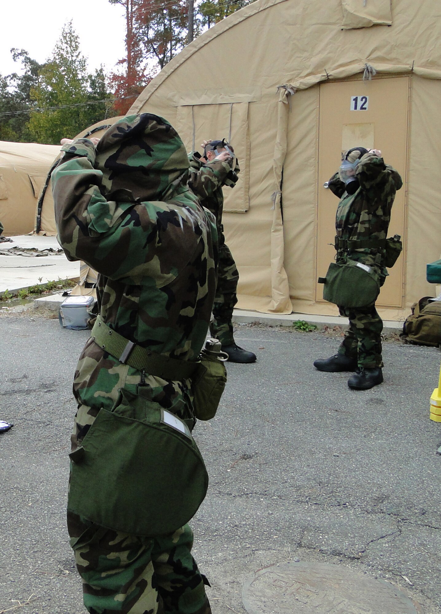 DOBBINS ARB, Ga.--Members of the 910th Force Support Squadron Readiness team are donning chemical warfare protective equipment during one one the ten judged events of the 2010 AFRC Force Support Readiness Competition held November 1-4, 2010. The 910th Force Support Squadron took first place out of five competing teams.  (U.S. Air Force photo/Tech. Sgt. Amber Leone)