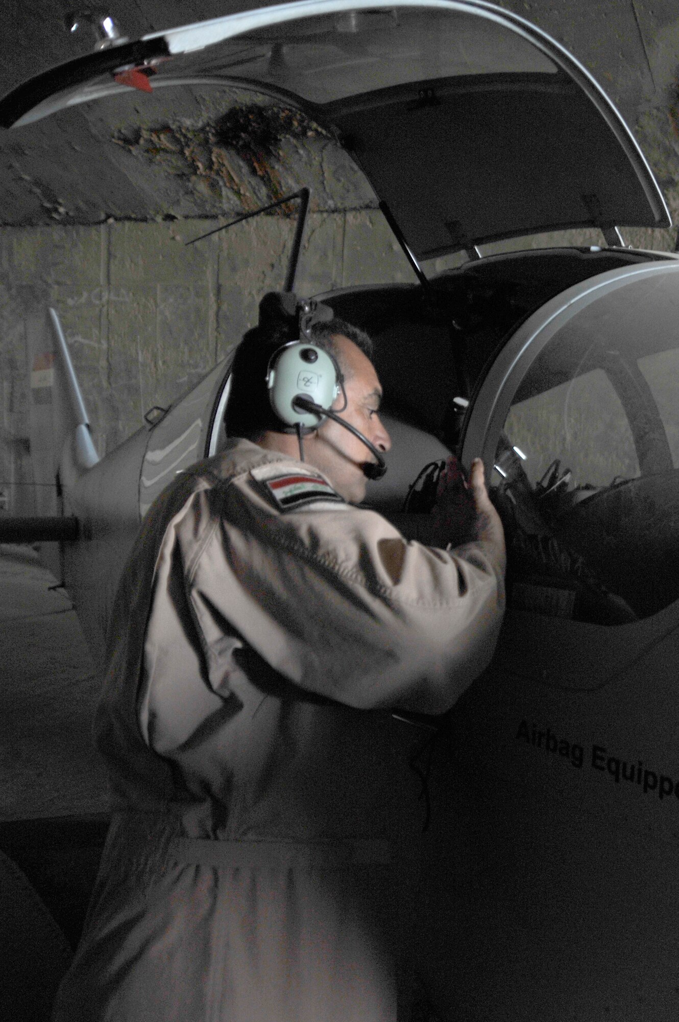 An Iraqi air force airman checks for damage after a sand storm, Oct. 24, 2010, at Ali Air Base, Iraq.  Iraqi air force Squadron 70 flew the aircraft to conduct intelligence, surveillance and reconnaissance missions.  (U.S. Air Force photo/Senior Airman Perry Aston)