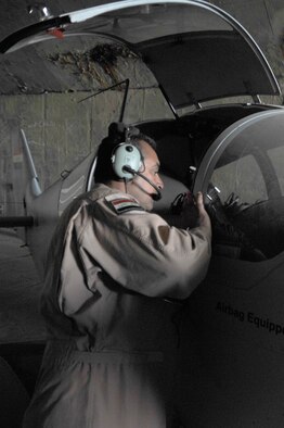 ALI AIR BASE, Iraq -- An Iraqi air force airman checks a CH-2000 for damage after a sand storm here Oct. 24. Iraqi air force Squadron 70, which recently arrived here from Basrah Air Base, flew the aircraft to conduct one of it's first intelligence, surveillance and reconnaissance missions from this location. U.S. Air Force photo by Senior Airman Perry Aston

