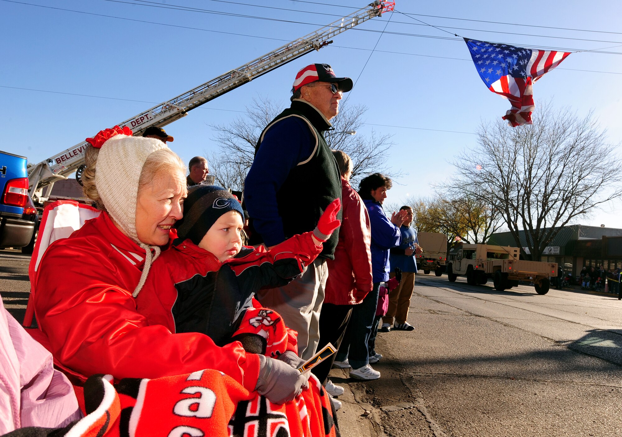 OFFUTT AIR FORCE BASE, Neb. -- Two-year-old Brett Bailey sits on his grandmother Kathy Bailey's lap during Nebraska's Official Veterans Parade Nov. 6 in Old Town Bellevue, Neb., Nov. 6.  The annual parade showcased more than 400 Team Offutt troops from the 55th Wing, U.S. Strategic Command, Air Force Weather Agency and Heartland of America Band. U.S. Air Force photo by Josh Plueger (Released)
