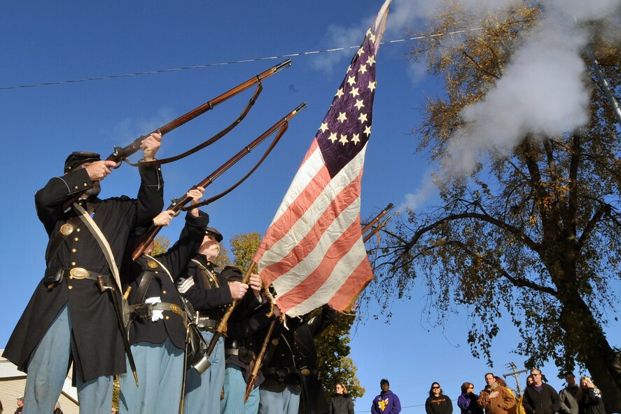 OFFUTT AIR FORCE BASE, Neb. -- Civil war re-enactment soldiers from the 1st Nebraska Volunteer Infantry give a gun salute during Nebraska's Official Veterans Parade Nov. 6 in Olde Towne Bellevue, Neb. Many local residents were on hand to watch the parade and honor the service and sacrifices of America's military veterans. U.S. Air Force photo by Jeff W. Gates.