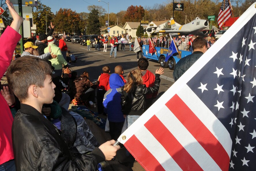 OFFUTT AIR FORCE BASE, Neb. -- Eric White, 12-year-old son of Army veteran Josh Meinders, holds his flag high in support of veterans during Nebraska's Official Veterans Parade Nov. 6 in Olde Towne Bellevue, Neb. Many local residents were on hand to watch the parade and honor the service and sacrifices of America's military veterans. U.S. Air Force photo by Jeff W. Gates.