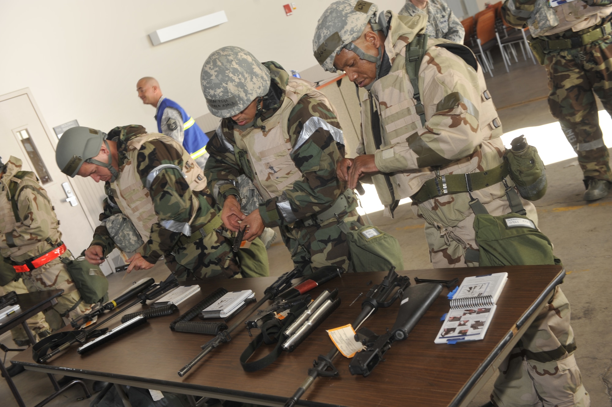 Airmen assemble M-16 rifles Nov. 2 during a 21st Space Wing quarterly Condor Crest exercise on Peterson Air Force Base. In this scenario, Airmen were deployed to “Tereen, Afghanistan” for a chemical war event. The focus of the exercise was to prepare Airmen to deploy into a chemical environment. The wing’s ability to perform deployment operations is among the areas expected to be scrutinized during an upcoming Operational Readiness Inspection conducted by the Air Force Space Command Inspector General. (U.S. Air Force photo/Robb Lingley)