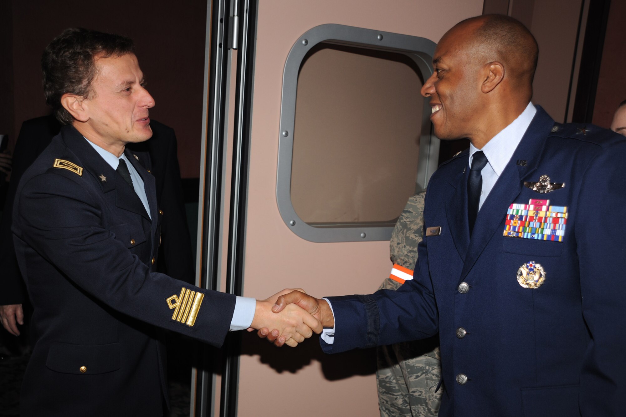 Brig. Gen. C.Q. Brown Jr., 31st Fighter Wing commander, (right), welcomes Col. Luca Cappelli, the Pagliano e Gori Airport commander, to the 31st FW Honorary Squadron Commander social held at the La Bella Vista Club on Area F of Aviano Air Base, Italy, Nov. 5, 2010.  The brief social allowed the HSC nominees to mingle with their respective unit commanders prior to the day’s events beginning. This was the first time Colonel Cappelli had taken part in the HSC program in which 11 Italians were inducted into that afternoon. The HSC program began at Aviano AB in 1997.  (U.S. Air Force photo/Tech. Sgt. Darrell Dean)
