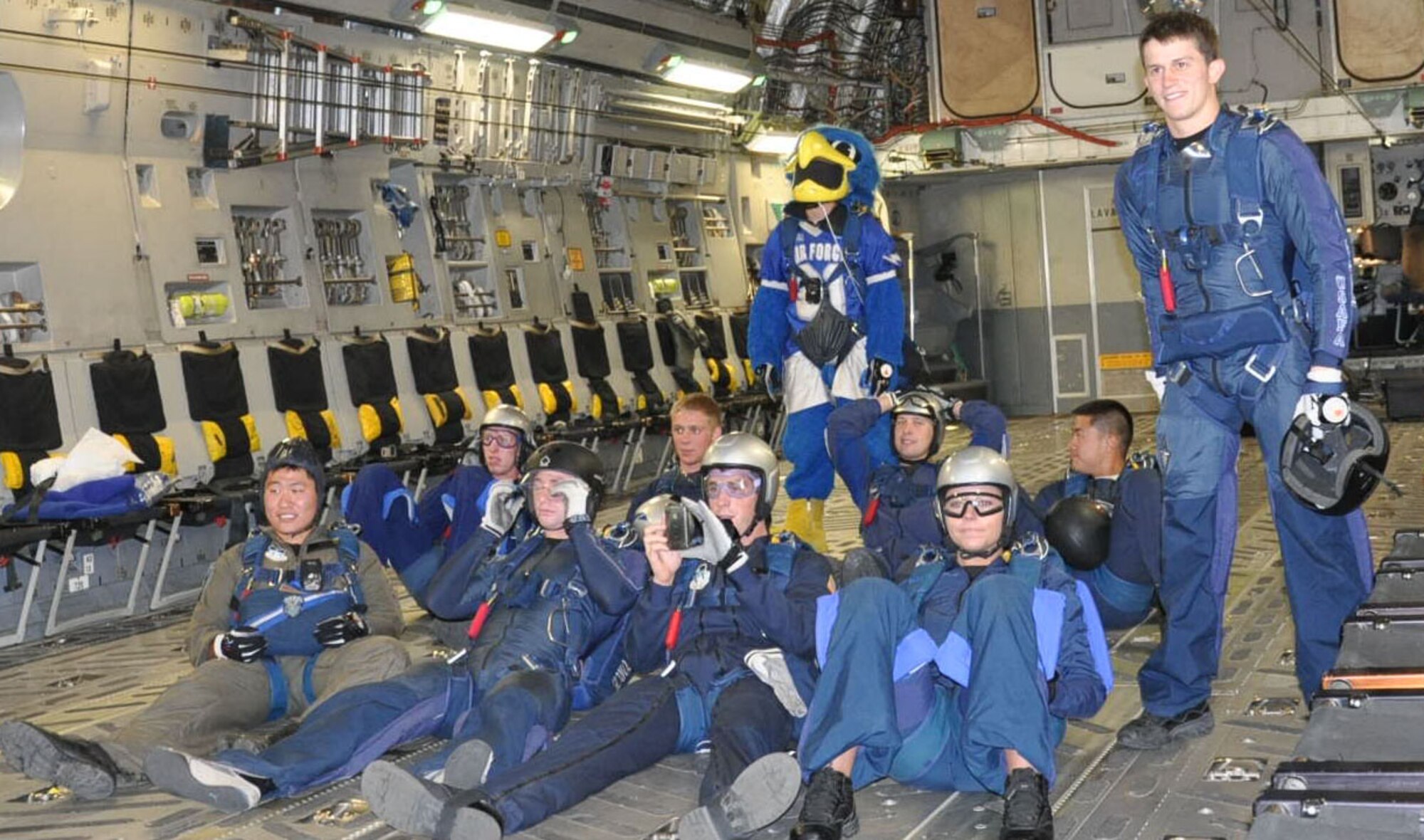 U.S. Air Force Academy, Colo.- The Air Force Academy Wings of Blue parachute team prepares to "drop in" the Air Force Academy Falcons game at Falcon Stadium, Oct. 30, from a C-17 Globemaster III flown by Reservists from the 97th Airlift Squadron. Most of the C-17 crew were also Air Force Academy graduates. Maj. Mike Parker class of 2000, Maj. Jason Allen class of 2000, Maj. Jon Mosier class of 1989, and Lt. Col. Dave Mets Class of 1989 got the chance to visit their alma mater and to cheer for the Falcons. (U.S. Air Force photo/Staff Sgt. Javier Cruz)