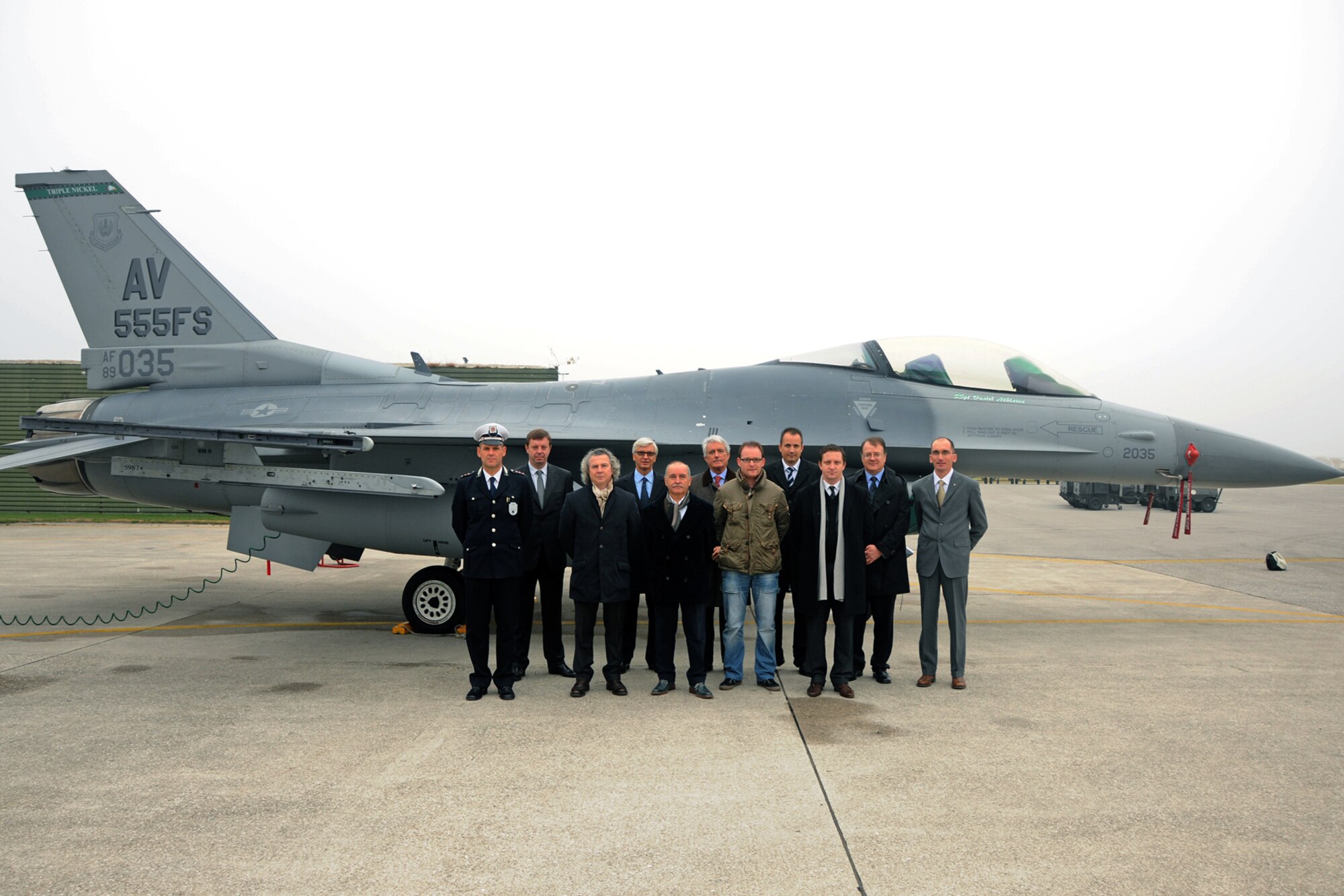 Eleven Italians take a group photo near the flightline area of Aviano Air Base, Italy, Nov. 5, 2010, as part of the 31st Fighter Wing Honorary Squadron Commander Program. The HSC program began at Aviano AB in 1997.  (U.S. Air Force photo/Tech. Sgt. Darrell Dean)