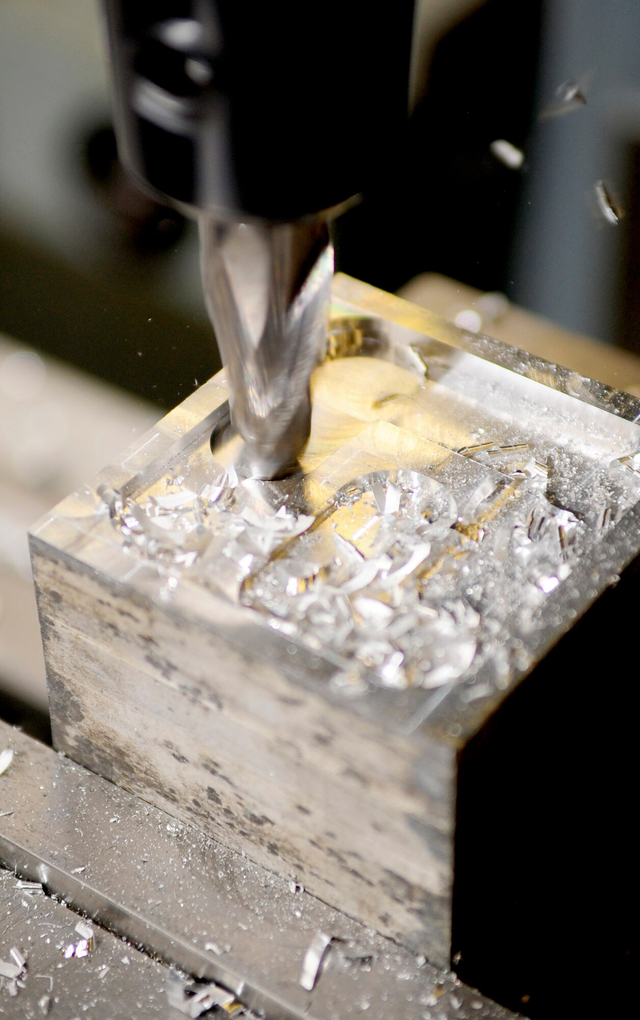 RAF MILDENHALL, England -- A pocket is cut into a block of metal with a horizontal milling machine Nov. 3, 2010. Pockets are cut into blocks of metal so that certain aircraft parts can be fabricated from them. (U.S. Air Force photo/Senior Airman Ethan Morgan) 