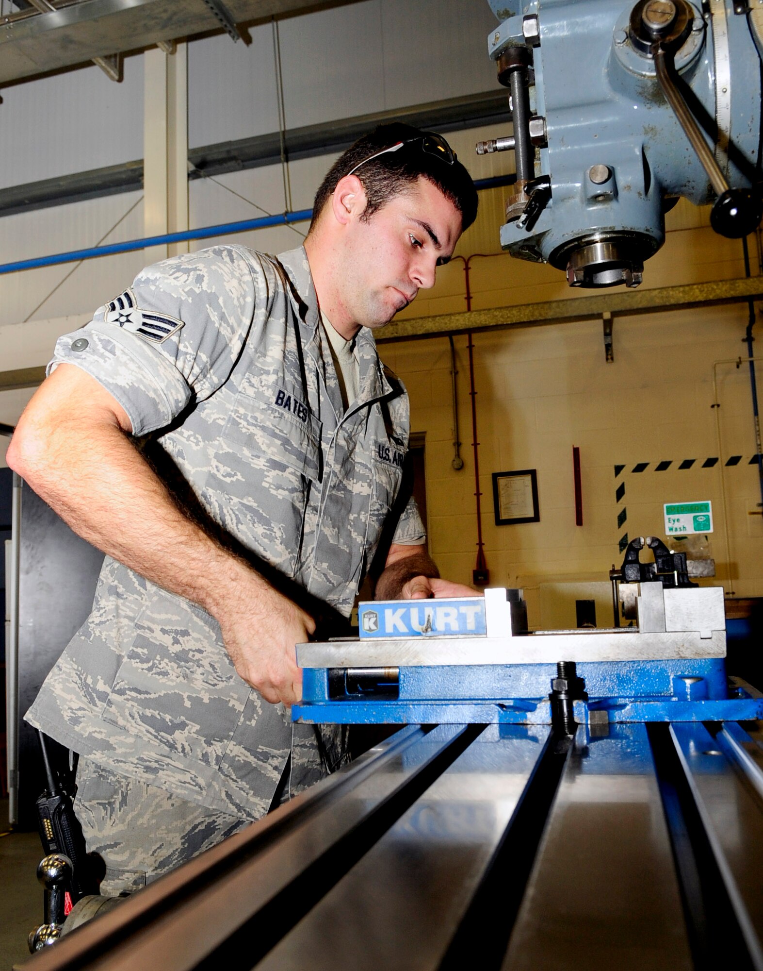 RAF MILDENHALL, England -- Senior Airman Brandon Bates, 100th Maintenance Squadron aircraft metals technology journeyman, prepares a horizontal milling machine for use Nov. 3, 2010. The milling machine is used to fabricate parts for aircraft. (U.S. Air Force photo/Senior Airman Ethan Morgan)