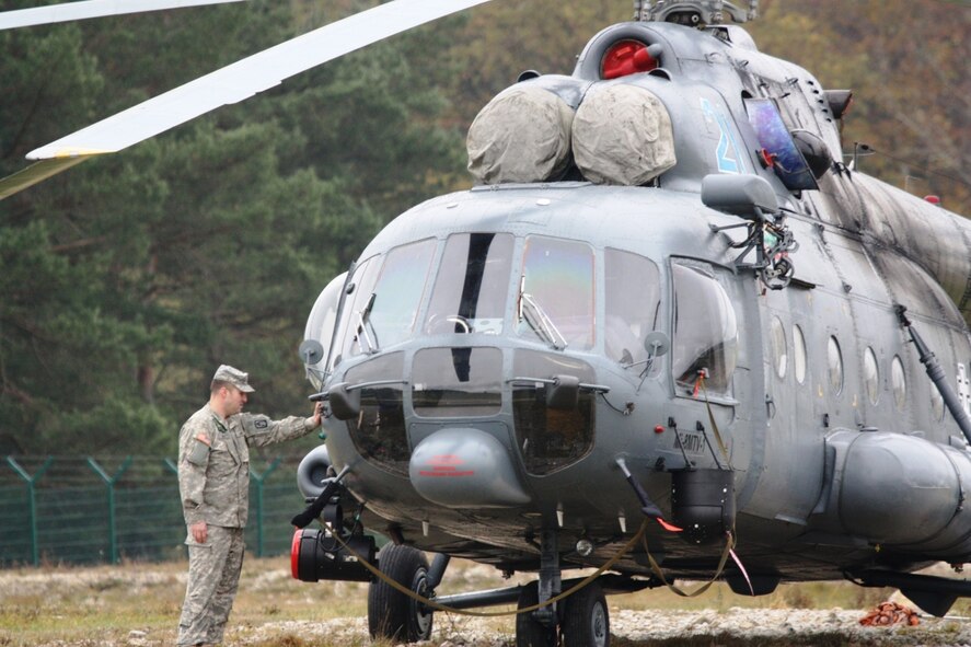 A U.S. Army aviator inspects a Czech Republic MI-8 Hip helicopter before it’s launched in support of combined training with the U.S. military and eight multinational partners during JMRC rotation 11-01 in Hohenfels, Germany.  (Casey Bain, JFIIT, USJFCOM) 