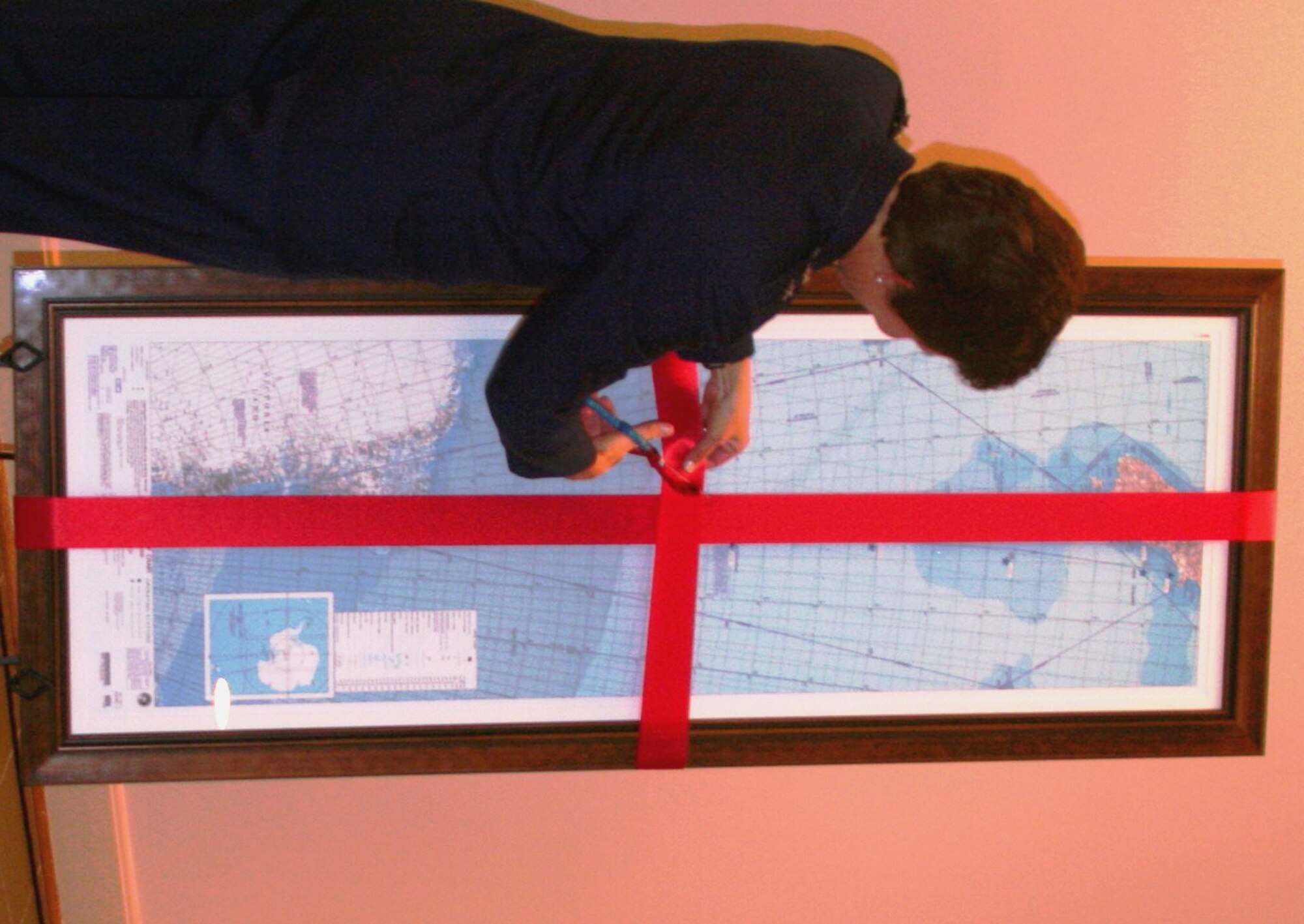 Maj. Gen. Susan Desjardins, Air Mobility Command's Director of Strategic Plans, Requirements and Programs at Scott Air Force Base, Ill., unveils a commemorative, centenary, first-edition Antarctic airway chart to the American Kennel Club Museum of the Dog in Saint Louis, Mo., on Nov. 2, 2010. The chart, created by Col. Ronald Smith who was commander of Operation Deep Freeze from 2005 to 2008, shows “Airway 338” waypoints with each waypoint named after sled dog teams of Norwegian explorer Roald Amundsen and the pony pack team of British explorer Capt. Robert Falcon Scott. The aeronautical chart is used in international flight navigation from New Zealand to Antarctica -- especially for Operation Deep Freeze. Colonel Smith is General Desjardins' Air National Guard advisor. (U.S. Air Force Photo/Master Sgt. Scott T. Sturkol)