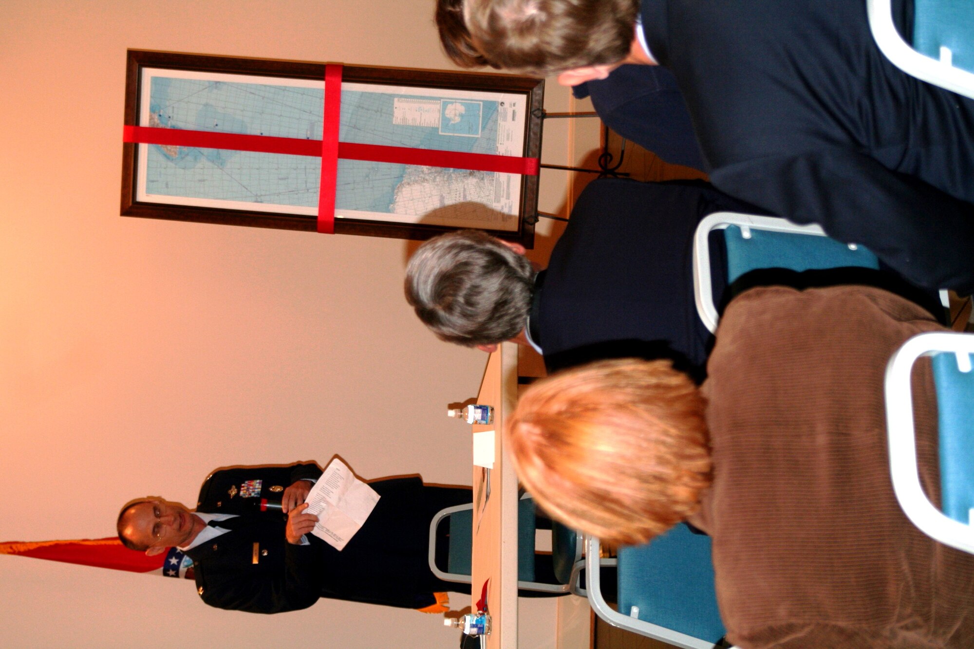 Col. Ronald Smith, from Headquarters Air Mobility Command at Scott Air Force Base, Ill., speaks about his inspirations for the design of a commemorative, centenary first edition Antarctic airway chart during a presentation of the chart at the American Kennel Club Museum of the Dog in Saint Louis, Mo., on Nov. 2, 2010. The chart, created by Colonel Smith who was commander of Operation Deep Freeze from 2005 to 2008, shows “Airway 338” waypoints with each waypoint named after sled dog teams of Norwegian explorer Roald Amundsen and the pony pack team of British explorer Capt. Robert Falcon Scott. The aeronautical chart is used in international flight navigation from New Zealand to Antarctica -- especially for Operation Deep Freeze. (U.S. Air Force Photo/Master Sgt. Scott T. Sturkol)