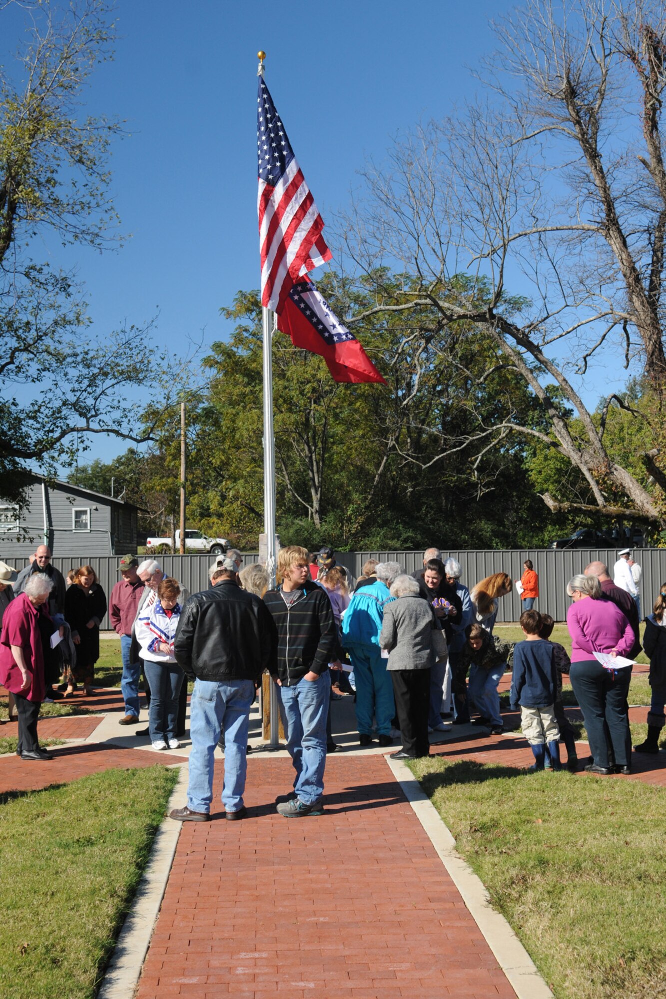 Families of the Fouke, Ark community look for veteran names on bricks at the Fouke, Ark. Veterans Park Memorial, Nov. 6, 2010. The park was dedicated on the same day after several years of fundraising and hard work put in by the local community. The city raised approximately $120,000 for the park. (U.S. Air Force/MSgt Greg Steele)
