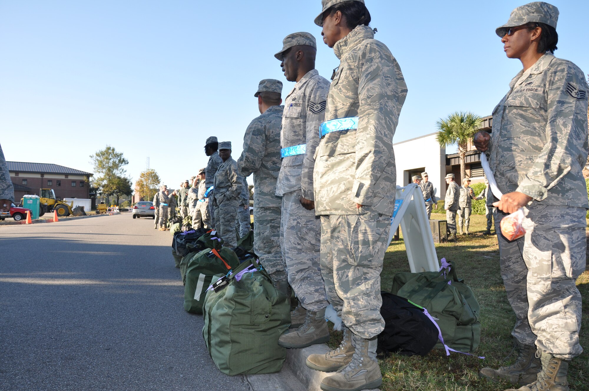 Members of the 315th Airlift Wing wait at a bus stop with mobility bags during the wing mobility execise during November UTA. Reservists received immunizations while support personnel trained on equiping the deployers in preparation for the upcoming ORI.