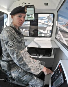 Staff Sgt. Amanda Cervantes, 902nd Security Forces Squadron, operates the controls to raise Skywatch, a mobile surveillance tower which has a variety of capabilities to watch and record a much wider area than the operator can on foot. (U.S Air Force Photo/Don Lindsey)