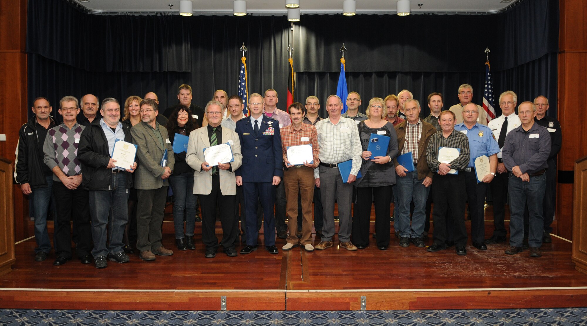 SPANGDAHLEM AIR BASE, Germany – Col. Christopher Weggeman, center, 52nd Fighter Wing commander, stands with wing civilian employees at the end of a Civil Length of Service ceremony Nov. 5. The wing recognized 32 civilian employees who have each served the U.S. government for 20 to 45 years. (U.S. Air Force photo/Staff Sgt. Benjamin Wilson)