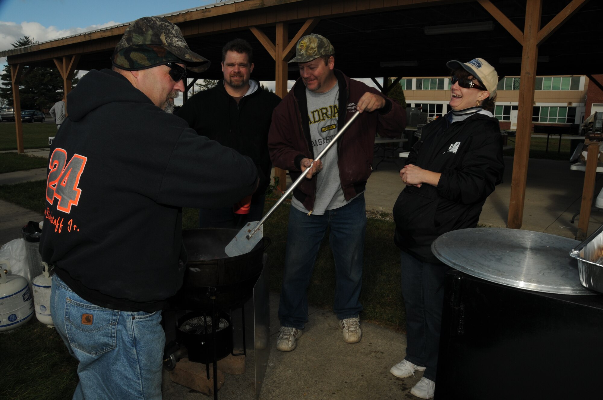 Members of the Ohio chapter of Barbecue for Our Troops huddle by one of five smokers used to feed hungry troops Oct 3, at the 180th Fighter Wing Pavillion. The picnic was provided by the group to celebrate the Excellent rating the base received in the Operational Readiness Inspection this summer and to salute our Hometown Heroes.