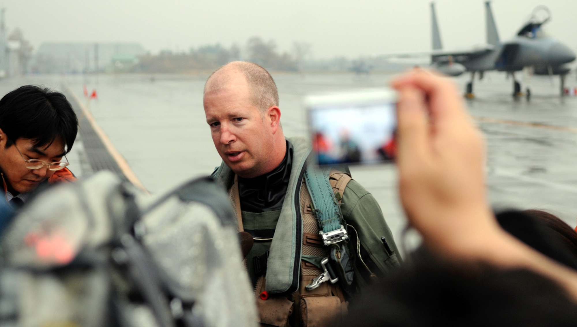 Lt. Col. Joel Carey, 44th Fighter Squadron commander, responds to a media question during the arrival press conference. Approximately 30 members of the press attended the event and asked questions about the importance and expectations of the Aircraft Training Relocation along with questions on Kadena Airmen involvement with the local communities. (U.S. Air Force photo by Tech. Sgt. Mike Tateishi)