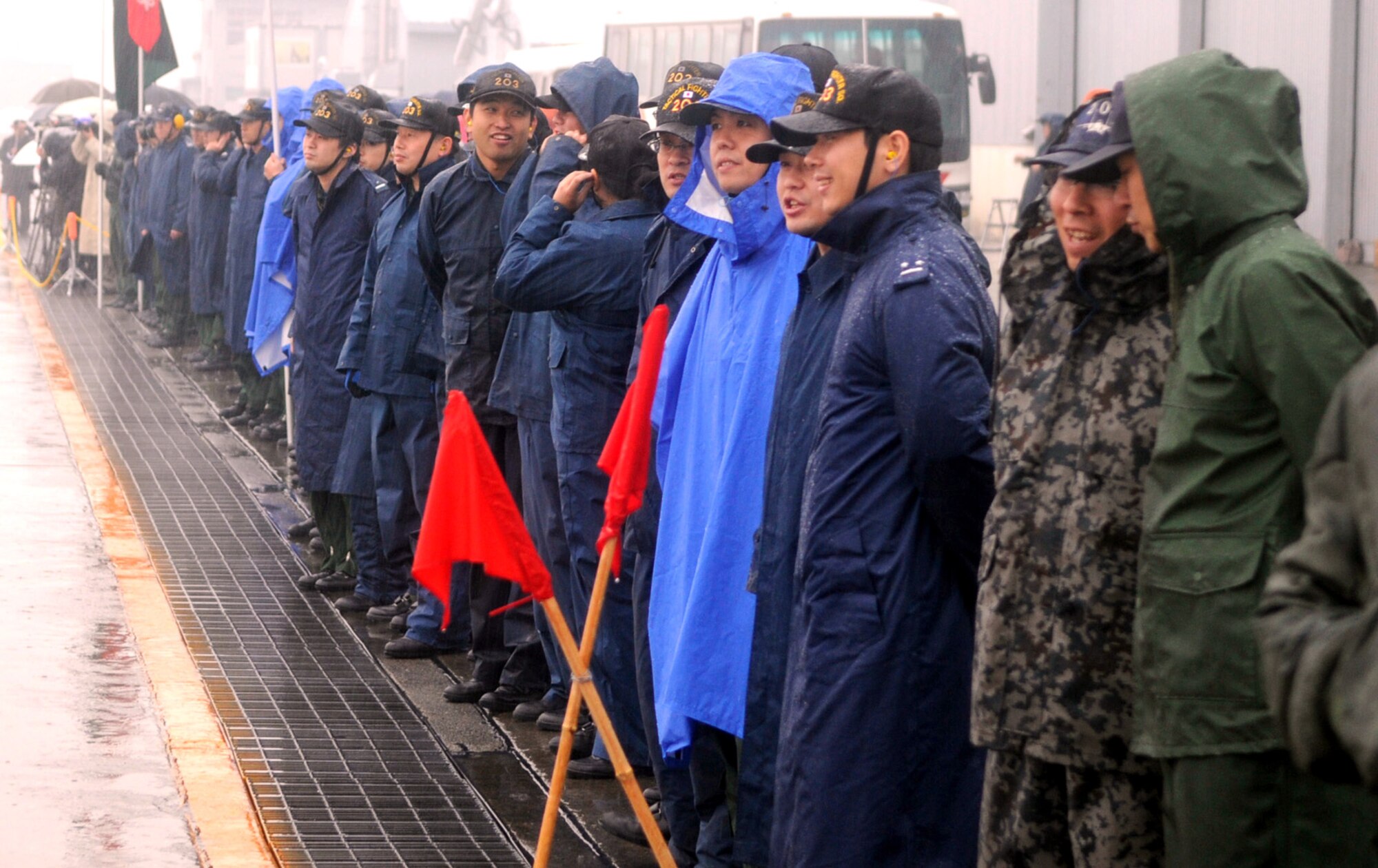 Members of the Japan Air Self Defense Force at Chitose Air Base, Hokkaido Prefecture, Japan, line the taxiway near the parking spots of arriving Kadena F-15s. Later, when Detachment and 44th Fighter Squadron Commander, Lt. Col. Joel Carey walked by they applauded and cheered to show their support of the Aircraft Training Relocation. (U.S. Air Force photo by Tech. Sgt. Mike Tateishi)