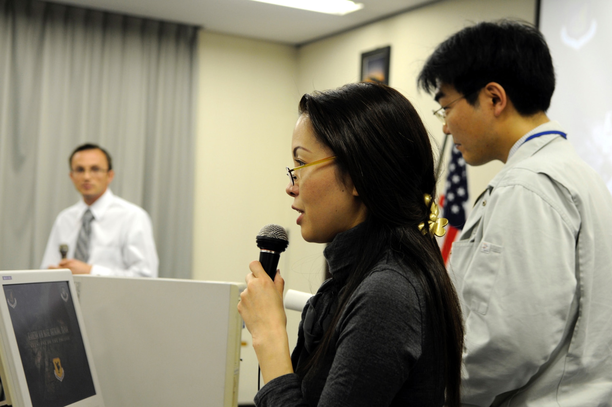 Sayaka Higa, center,  translates a response to a reporter’s question about the Kadena Aircraft Training Relocation that Ed Gulick, left, had just responded to. Both are from 18th Wing Public Affairs. Meanwhile, Kazushi Muraoka, Hokkaido Defense Bureau waits to translate the next question. About 80 local community leaders and 30 media representatives attended the event held at Chitose Defense Base in Chitose, Hokkaido Prefecture, Japan. Members of the HDB and 18th Wing gave informational briefings about the purpose and importance of the ATR along with responding to questions. (U.S. Air Force photo by Tech. Sgt. Mike Tateishi)