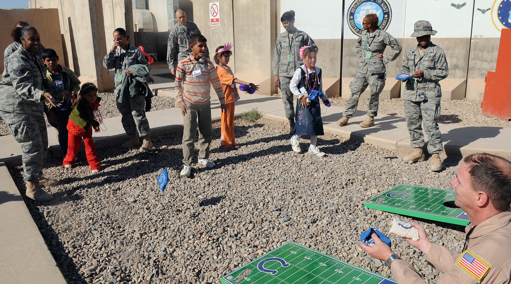 Iraqi Kids and their mentors take part in the bean bag toss during Iraqi kids Day Nov. 6, 2010, Joint base Balad, Iraq. More than 130 kids attended with 10 adult chaperones, and over 150 volunteers to assist with mentoring and leading the activities for the kids. “The excitement of the kids was written all over their faces, and just letting kids be kids is very rewarding,” said Capt. Daniel Coleman, 332nd Expeditionary Medical Group executive officer and Iraqi Kids day program coordinator. (U.S. Air Force Photo/ Senior Airman Marianne E. Lane)