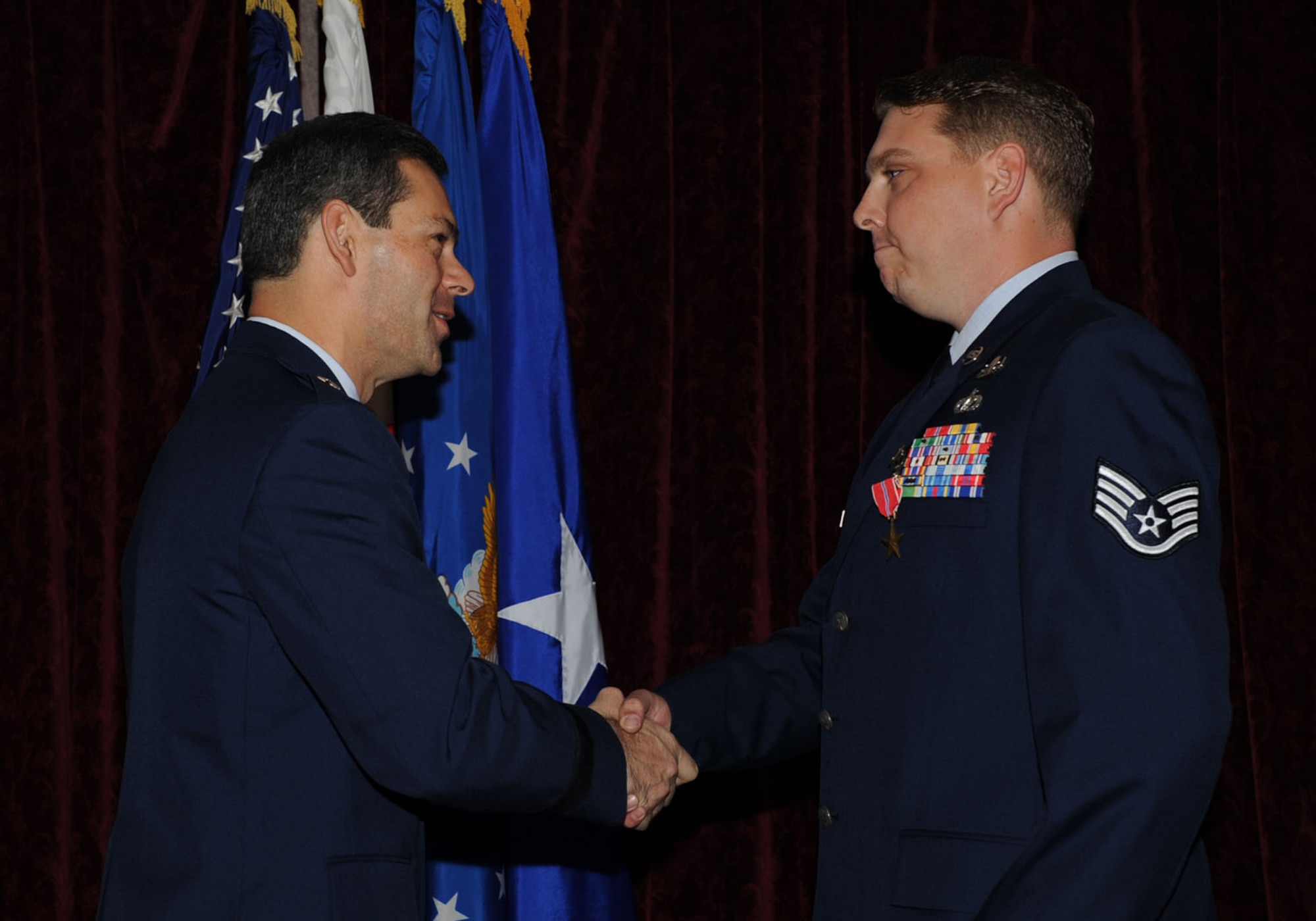 Brig. Gen. Ken Wilsbach presents the Bronze Star medal to Staff Sgt. Christopher Martin, 18th Civil Engineering Squadron, during a ceremony Nov. 5, at the Rocker NCO club.  Staff Sgt. Martin distinguished himself through exceptionally meritorious service in support of Operation Iraqi Freedom, Feb. 16 - Aug. 12, 2010. (U.S. Air Force photo/ Junko Kinjo)