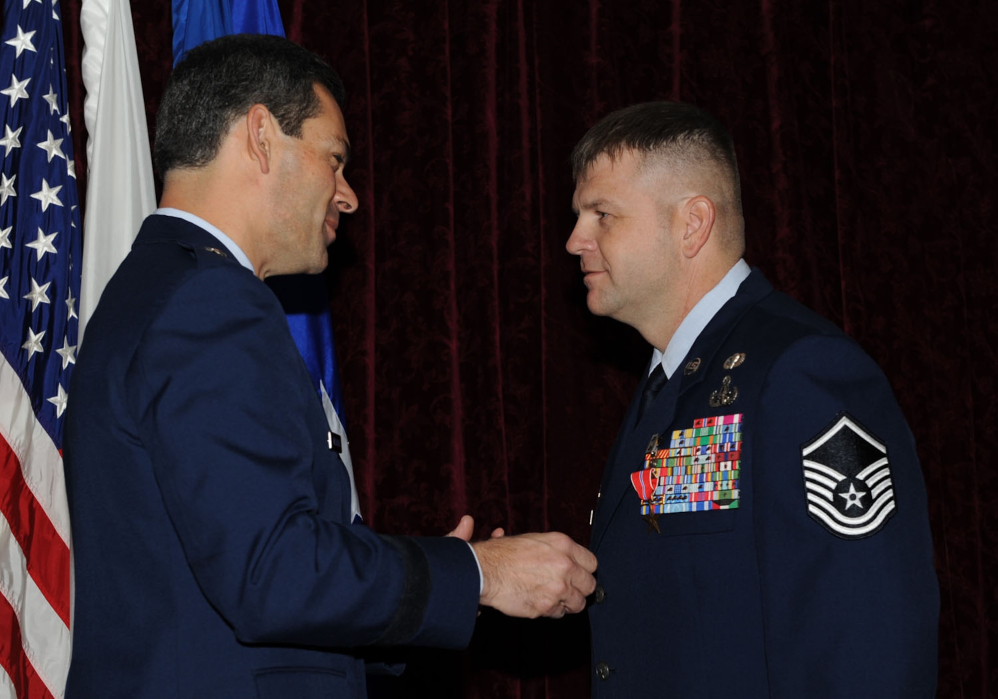 Brig. Gen. Ken Wilsbach presents the Bronze Star medal to Master Sgt. John Beebe, 18th Civil Engineering Squadron, during a ceremony Nov. 5, at the Rocker NCO club.  Master Sgt. Beebe distinguished himself through exceptionally meritorious service in support of Operation Enduring Freedom, March 24-Sept. 24, 2010. (U.S. Air Force photo/ Junko Kinjo)