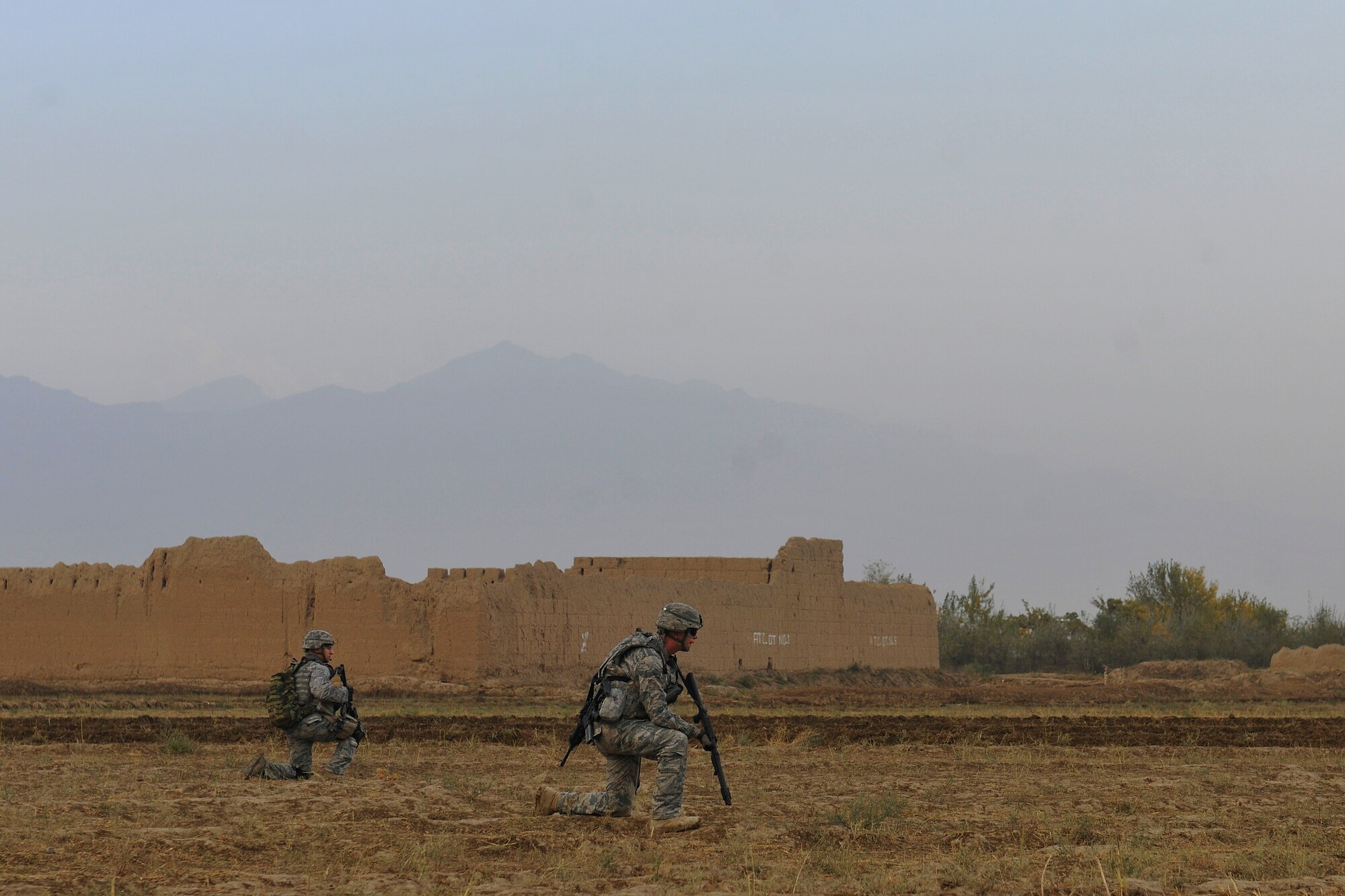 Airmen assigned to the 455th Expeditionary Security Forces Squadron set up a perimeter while on a dismounted patrol near Bagram Airfield, Afghanistan, November 5, 2010. The Airmen were conducting presence patrols and visiting with Afghans. (U.S. Air Force photo/Staff Sgt. Christopher Boitz)