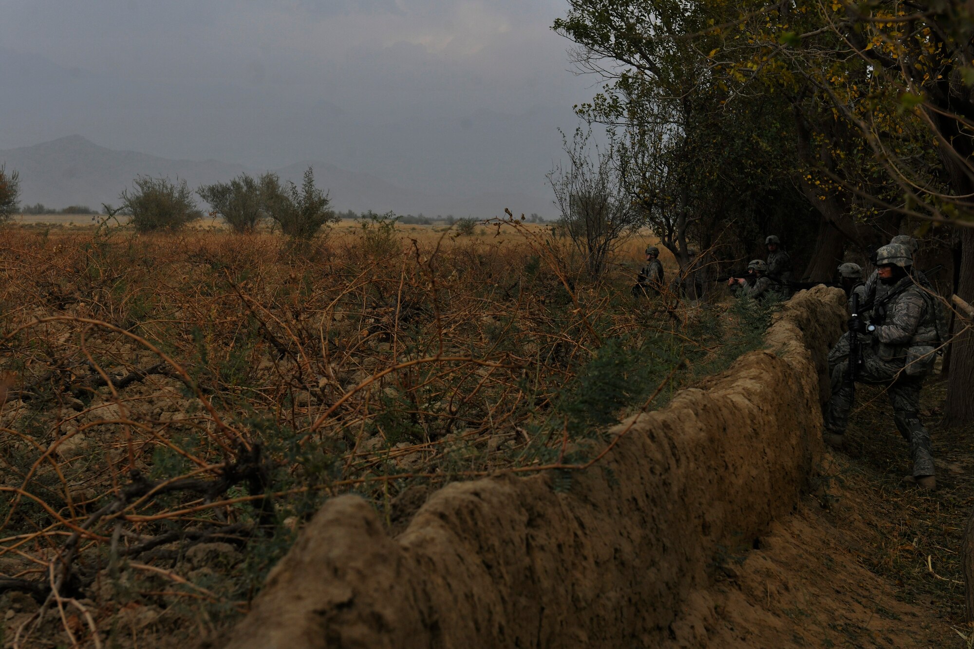 Airmen assigned to the 455th Expeditionary Security Forces Squadron look over a field while on a dismounted patrol near Bagram Airfield, Afghanistan, November 5, 2010. The Airmen were conducting presence patrols and visiting with Afghans. (U.S. Air Force photo/Staff Sgt. Christopher Boitz)