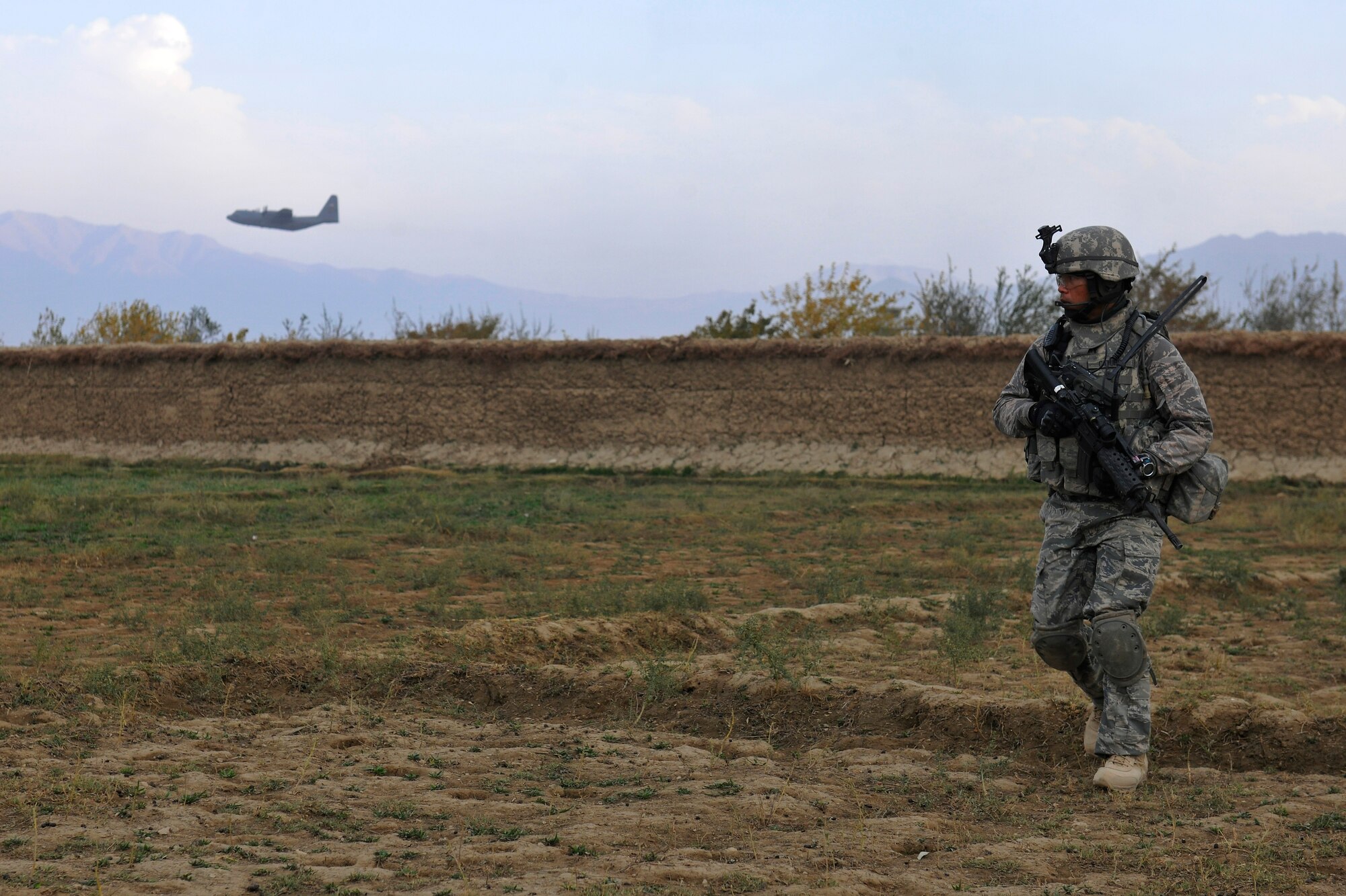 Master Sgt. Enrico Catubo, a flight sergeant assigned to the 455th Expeditionary Security Forces, walks through a field during a dismounted patrol near Bagram Airfield, Afghanistan, November 5, 2010. The Airmen were conducting presence patrols and visiting with Afghans. (U.S. Air Force photo/Staff Sgt. Christopher Boitz)