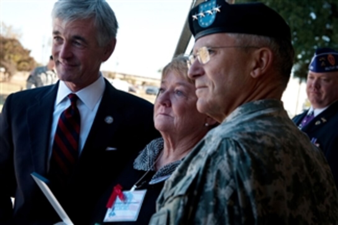 Christine Gaffaney (2nd from left), widow of Cpt. John Gaffaney, poses for a photo with the Secretary of the Army John Mchugh (left) and Chief of Staff of the Army Gen. George W. Casey Jr. after she was presented an award during a remembrance ceremony at Fort Hood, Texas, on Nov. 5, 2010.  The ceremony marked the anniversary of the shootings that claimed 13 victims on November 5, 2009.  